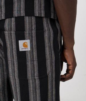 Carhartt WIP Dodson Short in Stripe Black. Detail angle model shot at EQVVS.