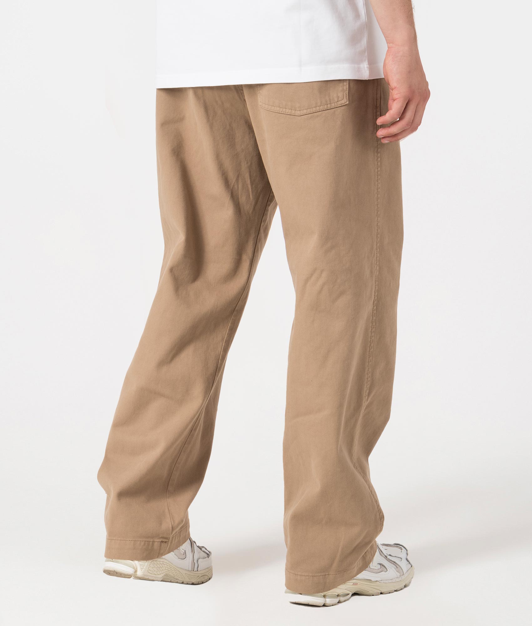 Carhartt WIP Relaxed Fit Floyde Pants in Leather. Back angle model shot at EQVVS.
