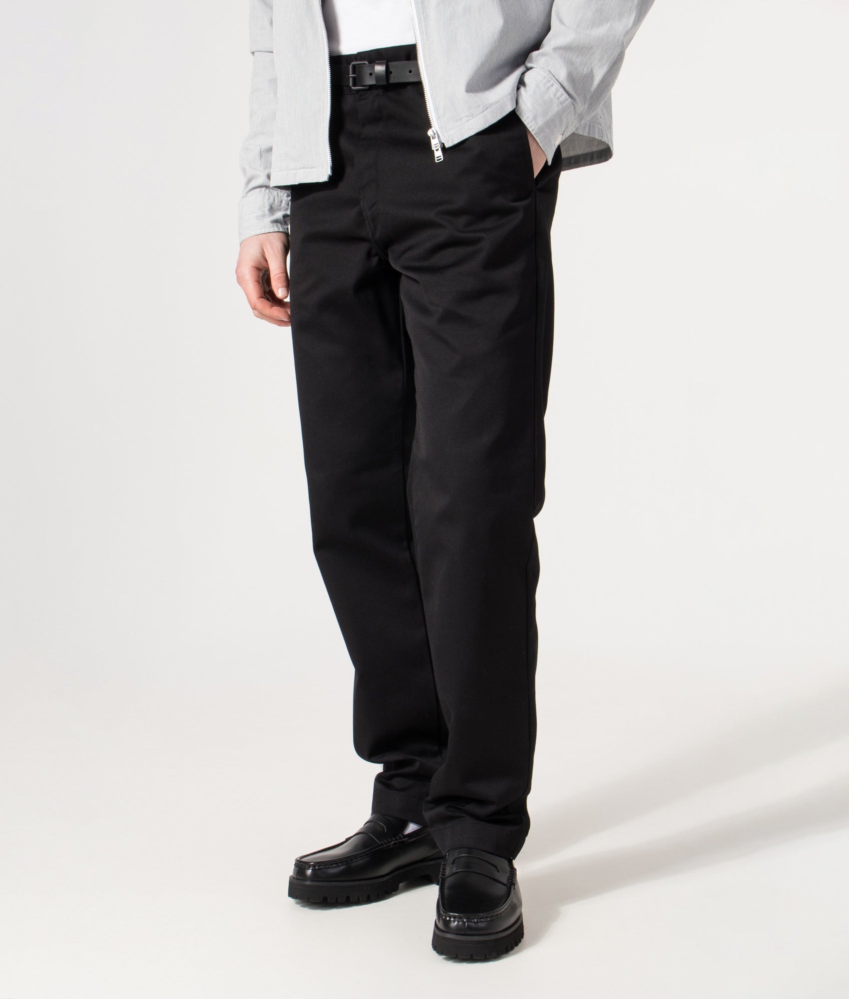 Carhartt WIP Relaxed Fit Tapered Master Pants in Black at EQVVS Menswear. Angled model front shot.