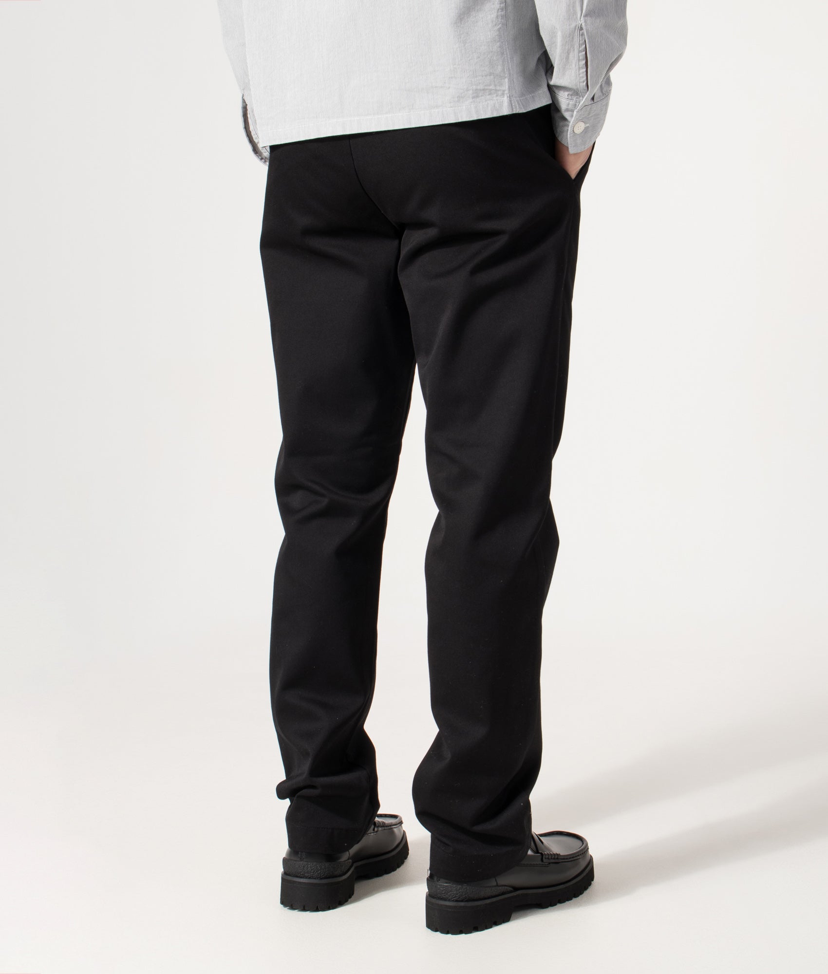 Carhartt WIP Relaxed Fit Tapered Master Pants in Black at EQVVS Menswear. Model back shot.