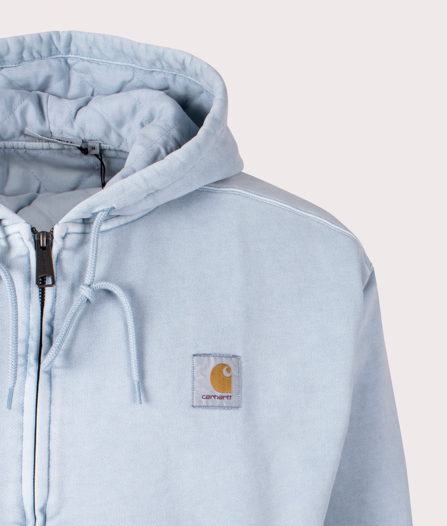 Carhartt WIP Oversized Vista Jacket in Dusty Ice, 100% Cotton at EQVVS. Detail logo shot. 