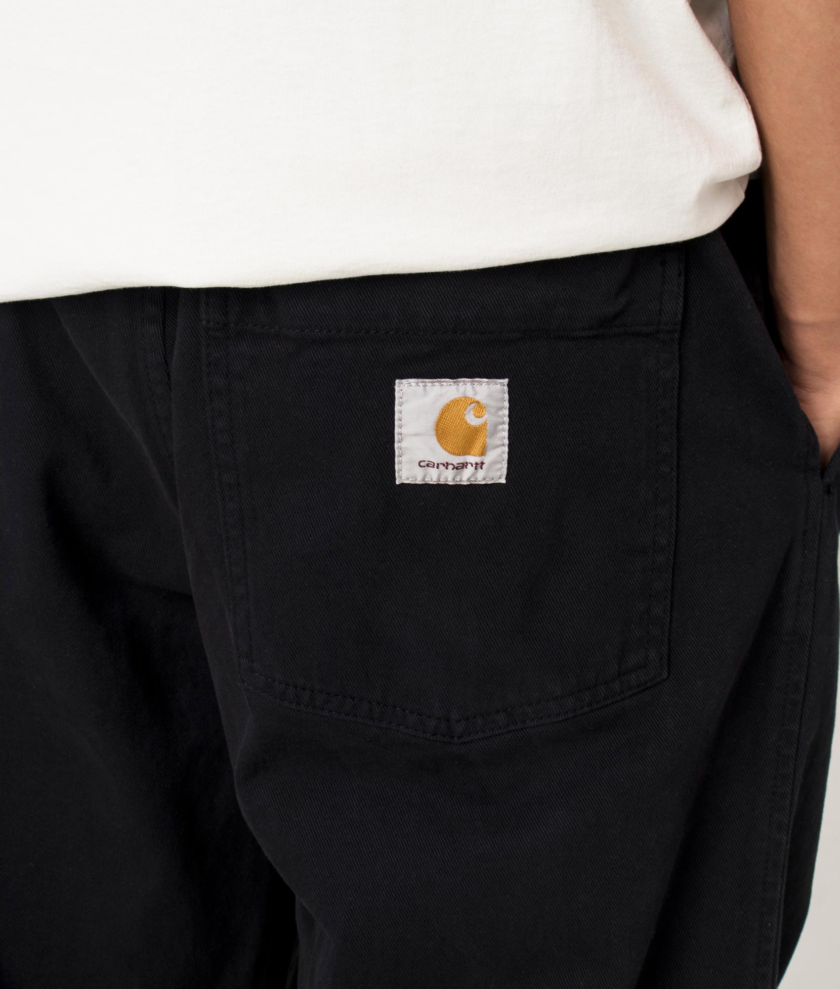 Carhartt WIP Relaxed Fit Floyde Pants in Black at EQVVS Menswear. Detail shot.