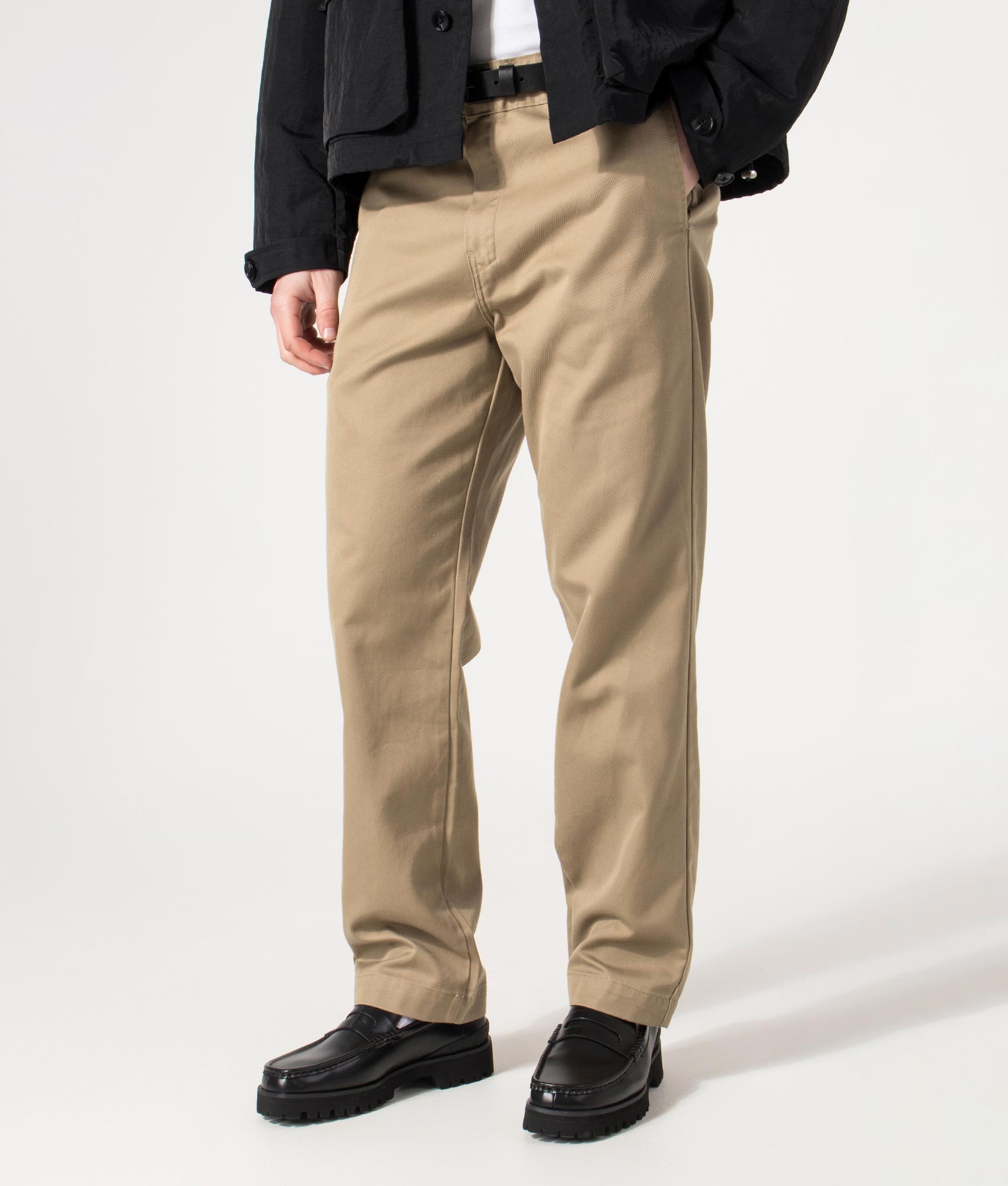 Carhartt WIP Relaxed Fit Tapered Master Pants in Leather Rinsed at EQVVS Menswear. Angled model front shot.
