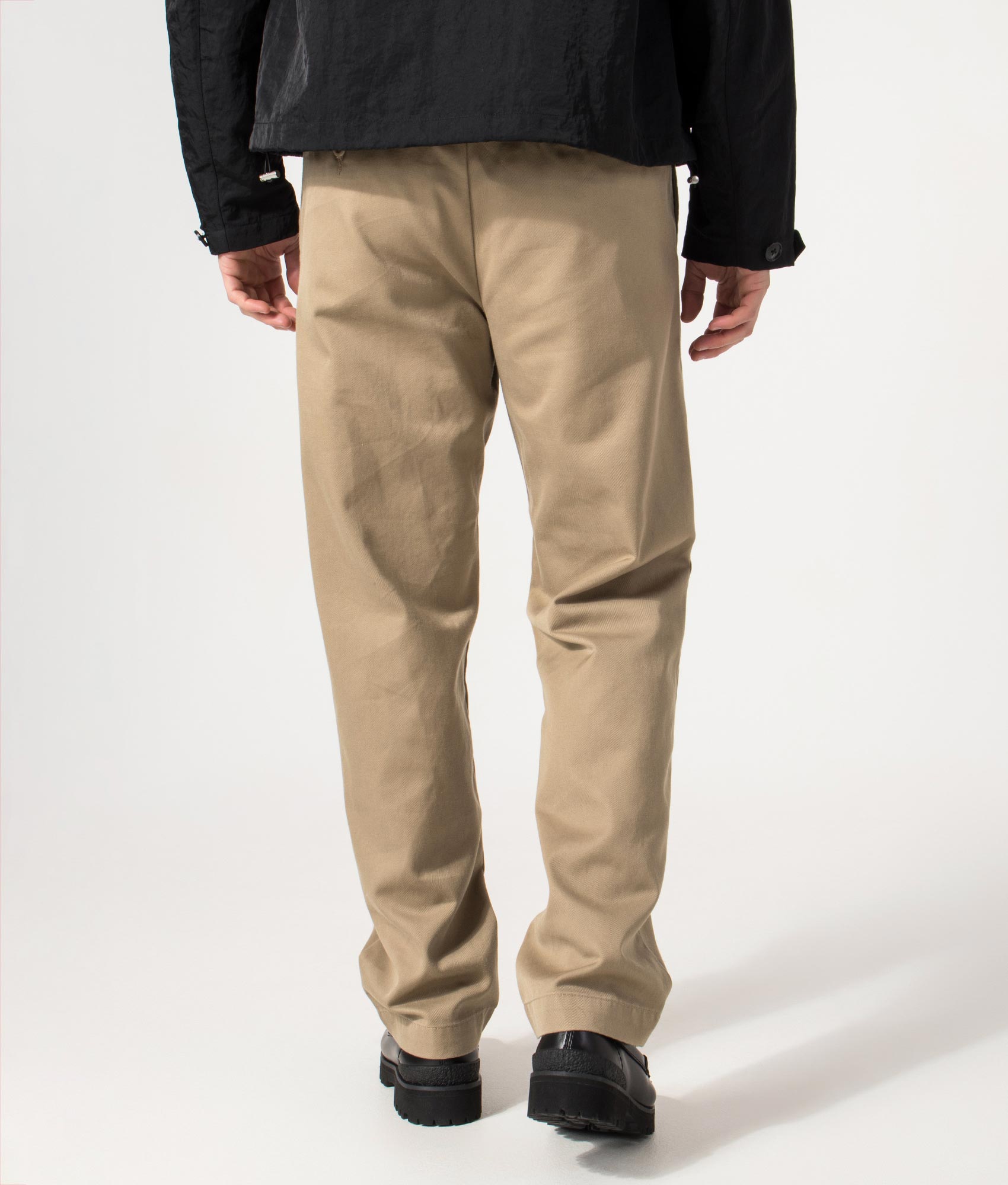 Carhartt WIP Relaxed Fit Tapered Master Pants in Leather Rinsed at EQVVS Menswear. Model back shot.