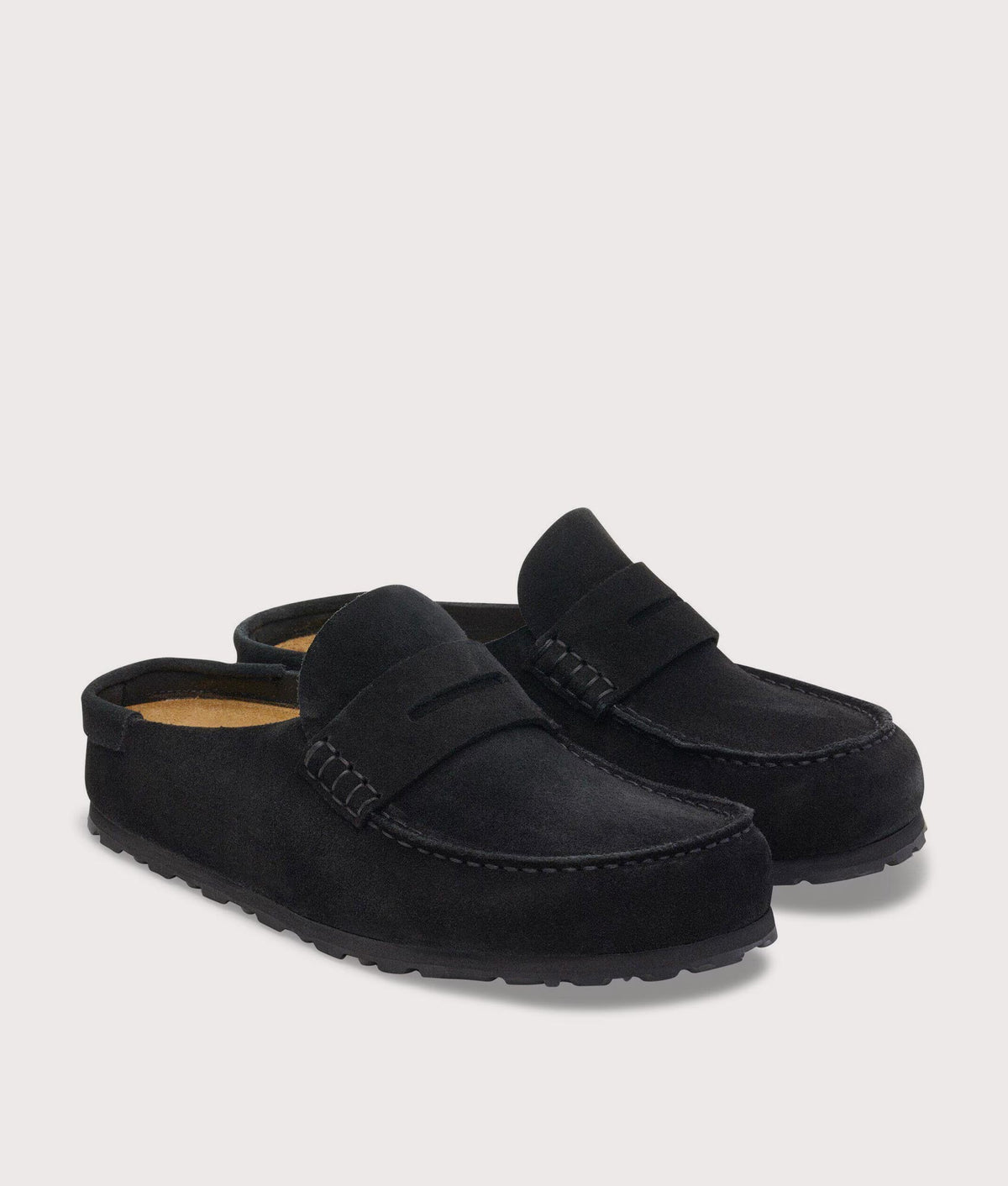 BIRKENSTOCK Naples Wrapped Suede Leather Clogs in Black at EQVVS Menswear. Angled front shot.