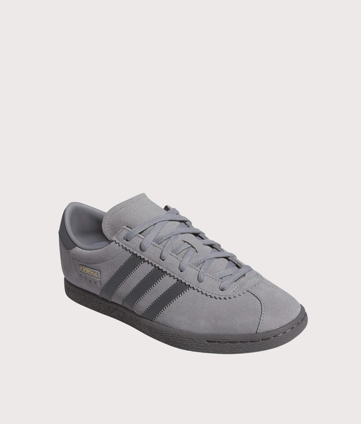 adidas Originals Stadt Trainers in Grey Three, Grey Five and Gold Metallic at EQVVS Menswear. Angled front shot.