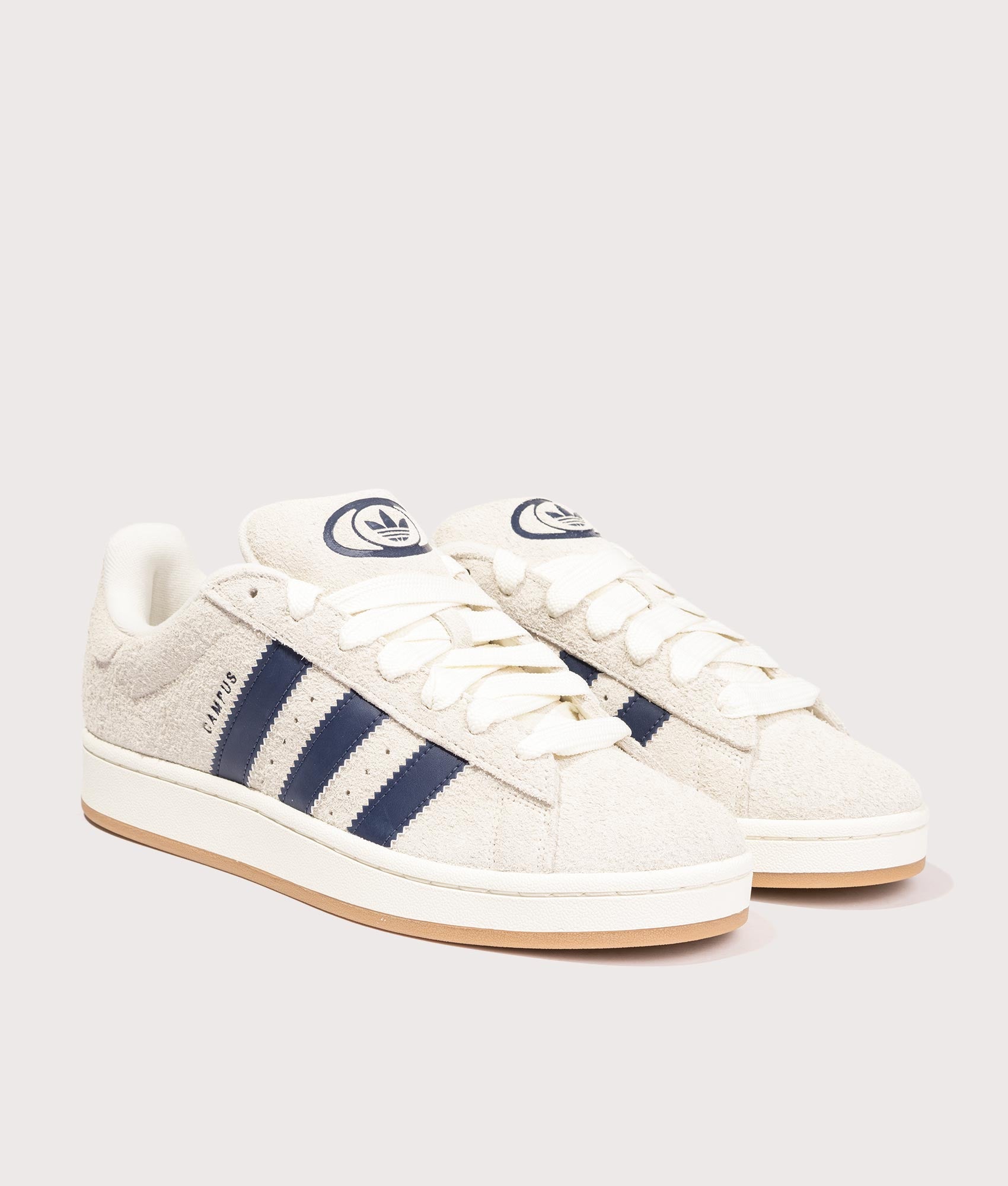 adidas Originals Campus 00s Trainers in Cream White/ Dark Blue/ Off White, 100% Leather and Rubber at EQVVS. Side pair shot. 