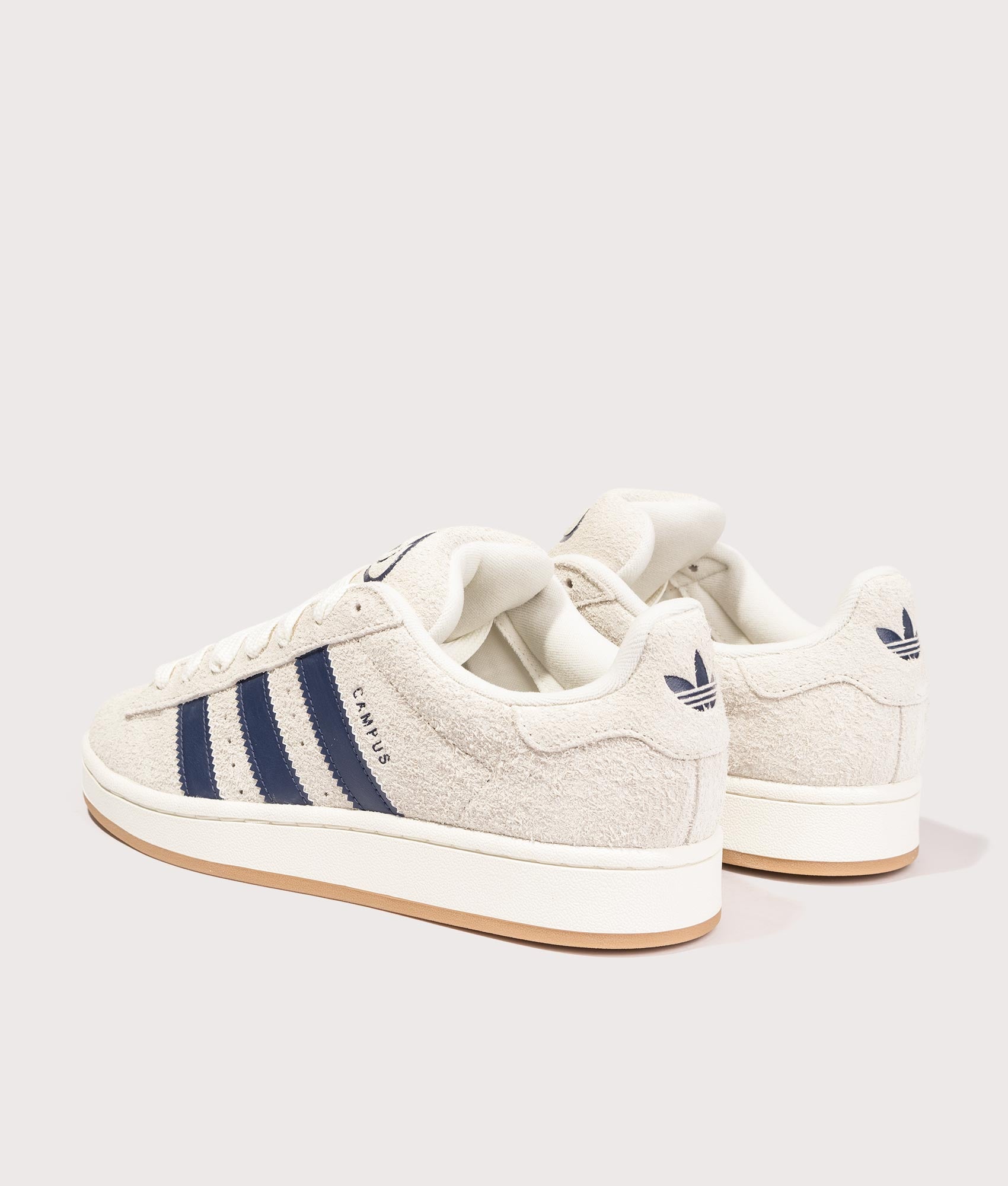 adidas Originals Campus 00s Trainers in Cream White/ Dark Blue/ Off White, 100% Leather and Rubber at EQVVS. Back pair shot. 