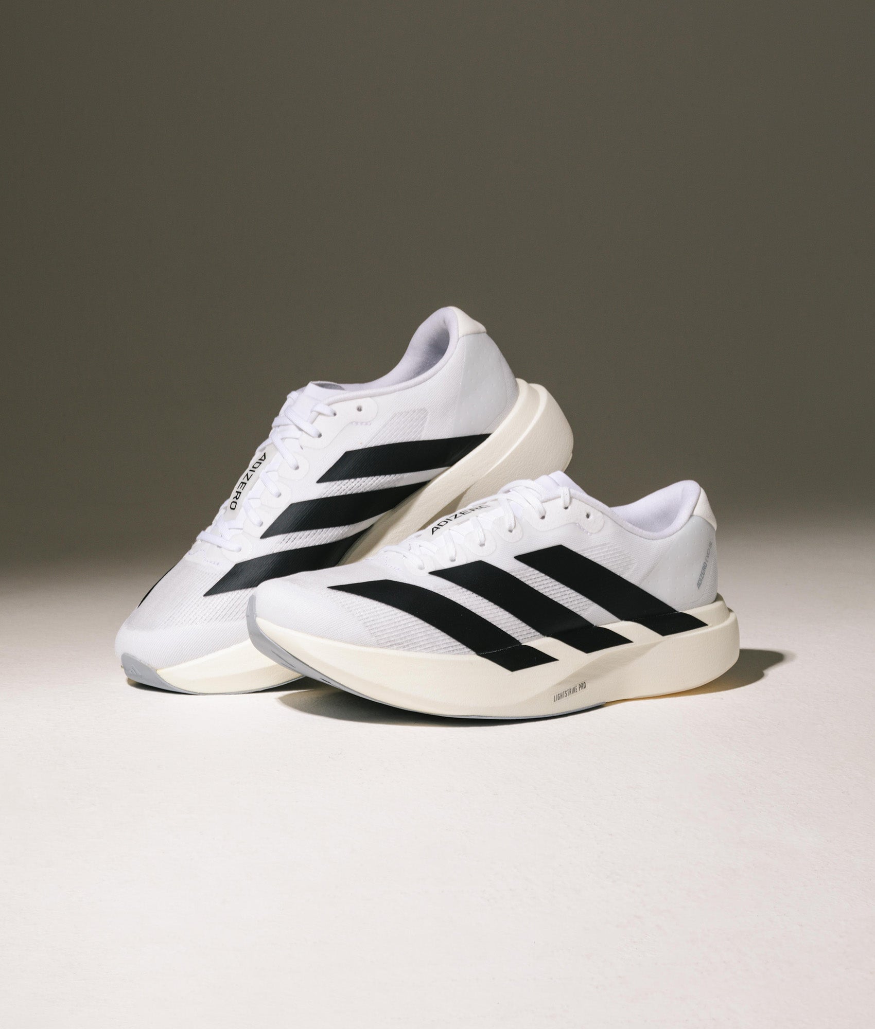 adidas Originals Adizero Evo SL Trainers in Cloud White/Core Black/Cloud White at EQVVS Menswear. Campaign shot.