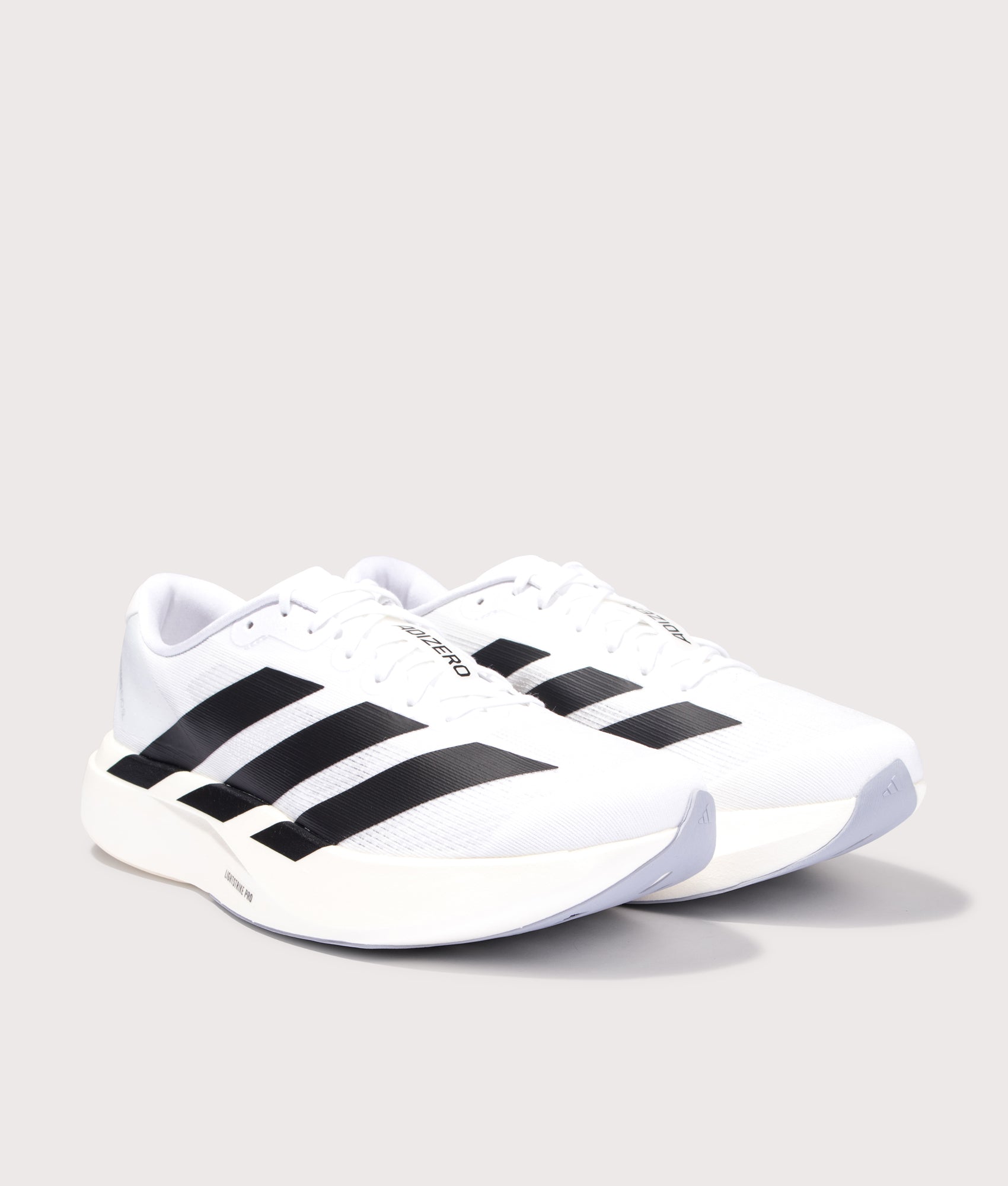 adidas Originals Adizero Evo SL Trainers in Cloud White/Core Black/Cloud White at EQVVS Menswear. Angled front shot.