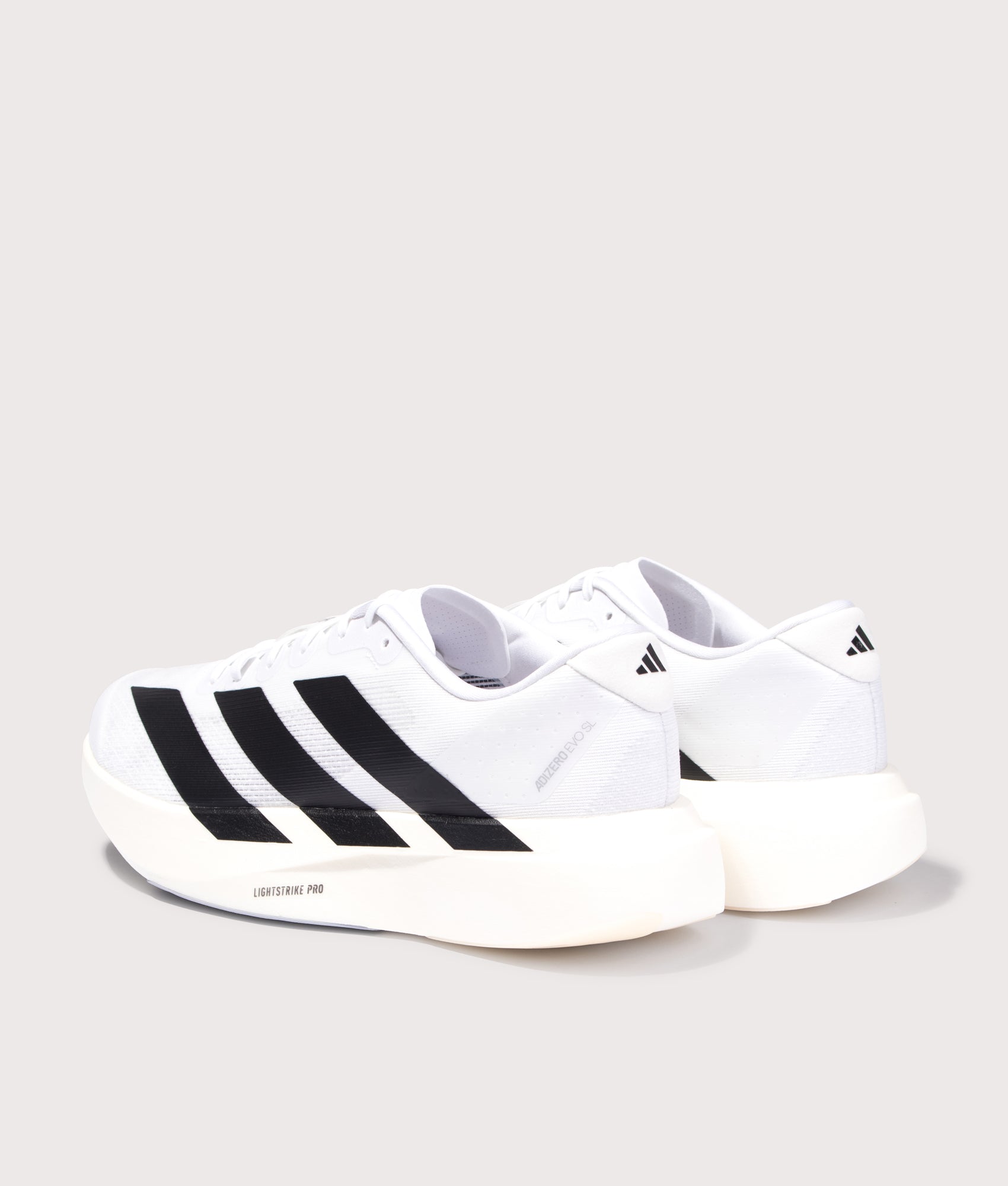 adidas Originals Adizero Evo SL Trainers in Cloud White/Core Black/Cloud White at EQVVS Menswear. Angled back shot.