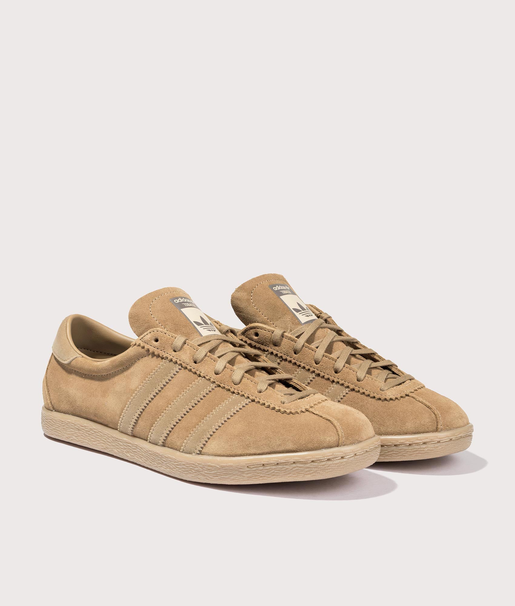 adidas Originals Tobacco Trainers in Brown desert/Cardboard/Gum4 at EQVVS Menswear. Angled front shot.