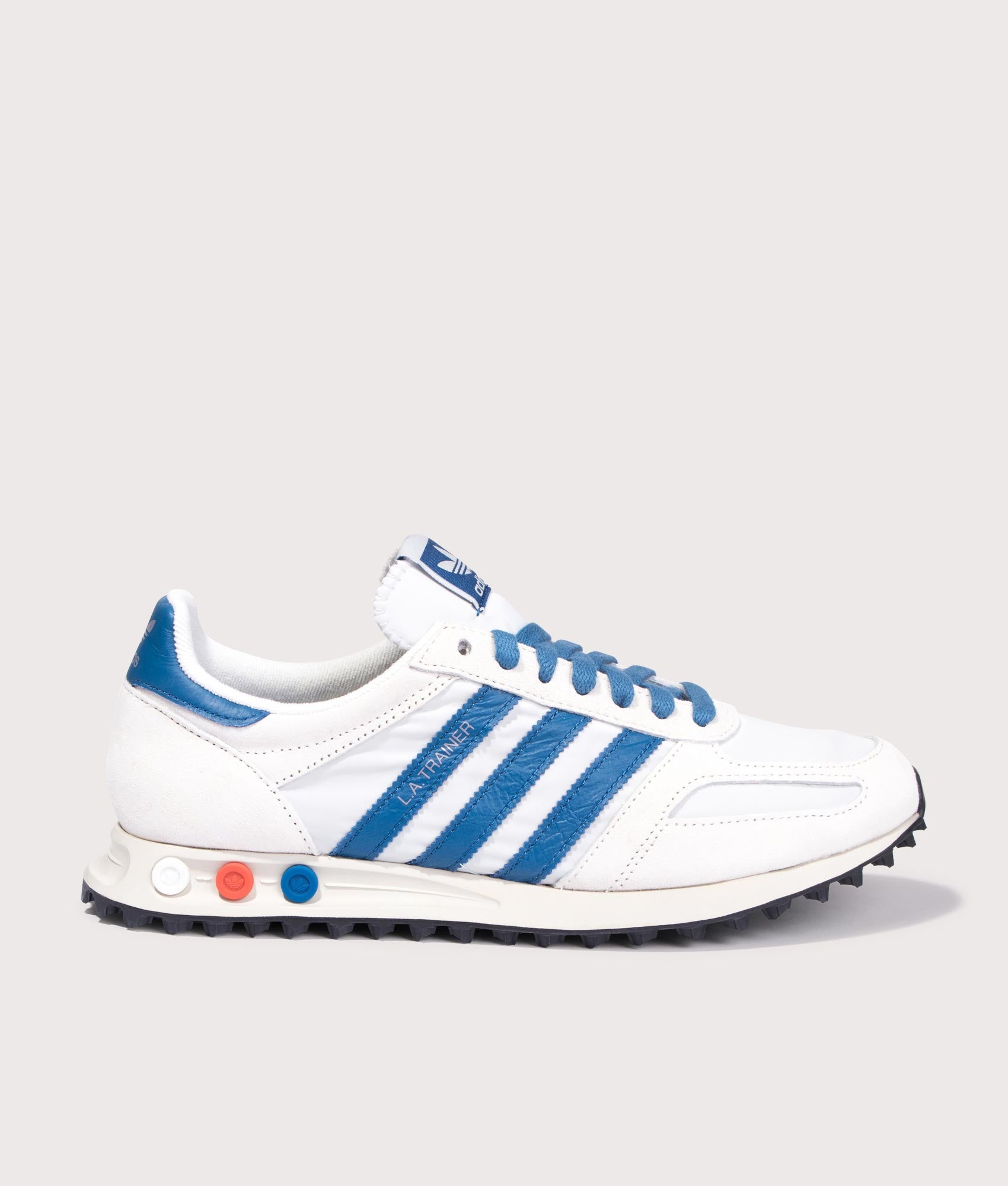 Adidas Originals LA Trainers in Off White, Dark Marine and Crystal White at EQVVS Menswear. Side shot.