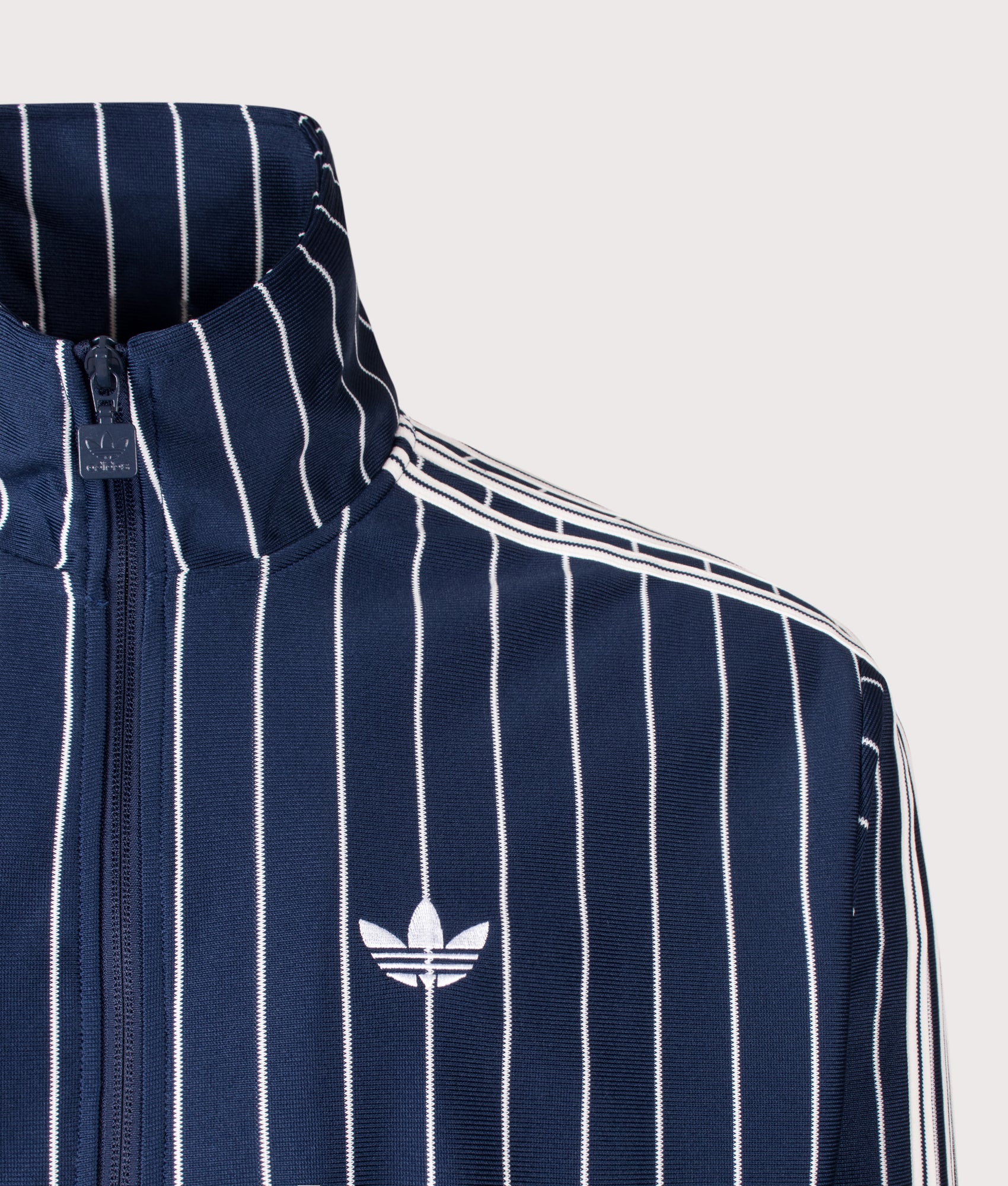 adidas Originals Loose Fit Firebird Pinstripe Track Top in Night Indigo at EQVVS Menswear. Detail shot.