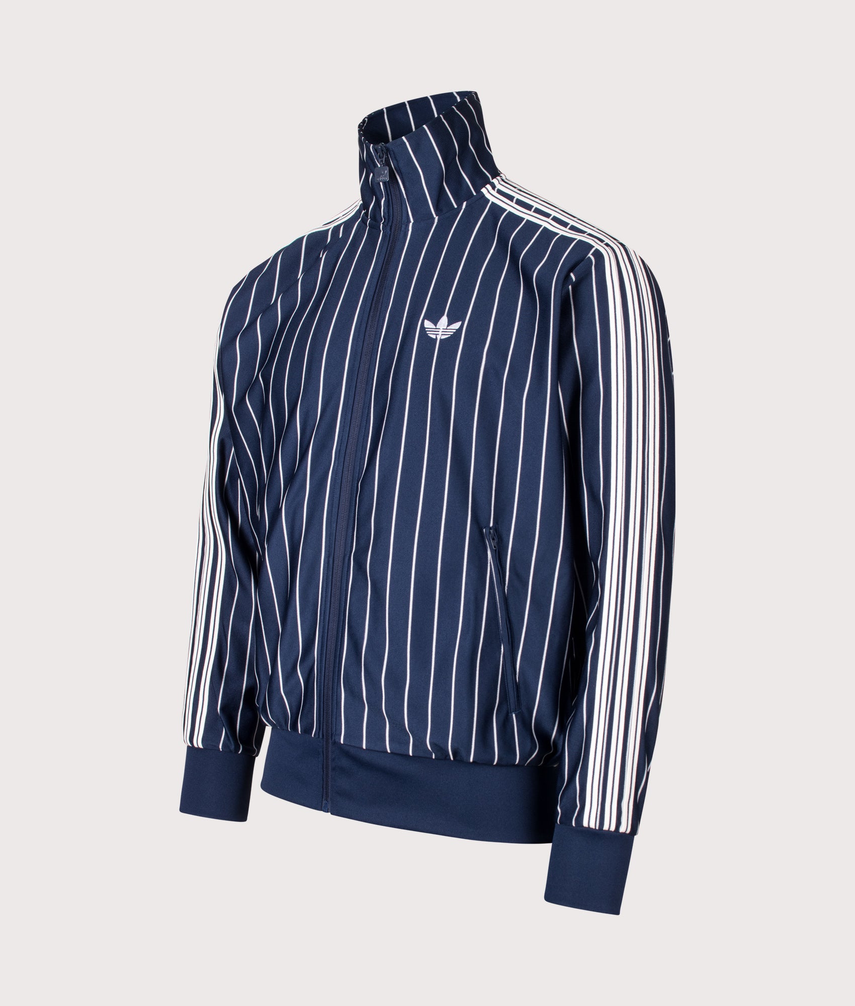 adidas Originals Loose Fit Firebird Pinstripe Track Top in Night Indigo at EQVVS Menswear. Angled front shot.