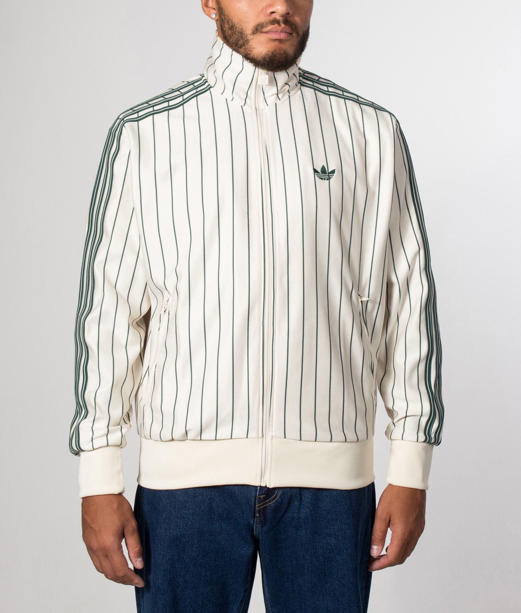 adidas Originals Loose Fit Firebird Pinstripe Track Top in in Pin stripe Warm Vanilla at EQVVS Menswear. Model front shot.