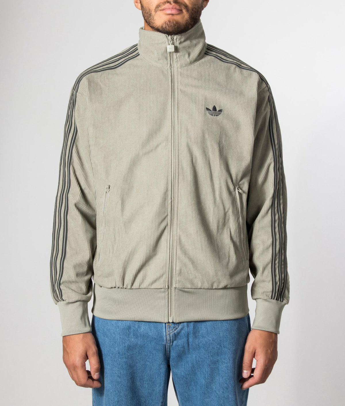 adidas Originals Loose Fit Firebird Corduroy Track Top in Silver Pebble at EQVVS Menswear. Model front shot.