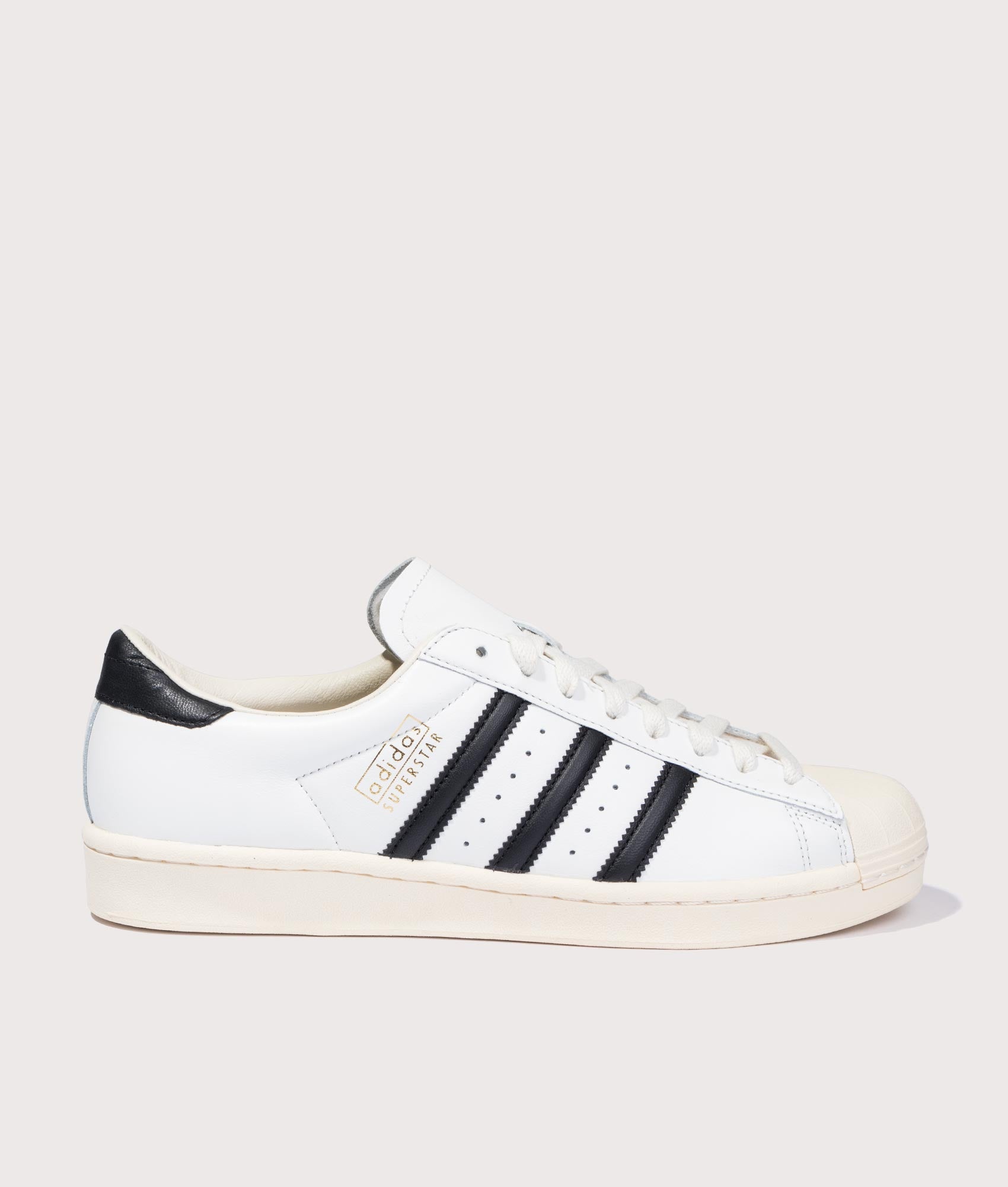 adidas Originals Superstar Vintage Trainers in Cloud White, Core Black and Cream White at EQVVS Menswear. Side shot.