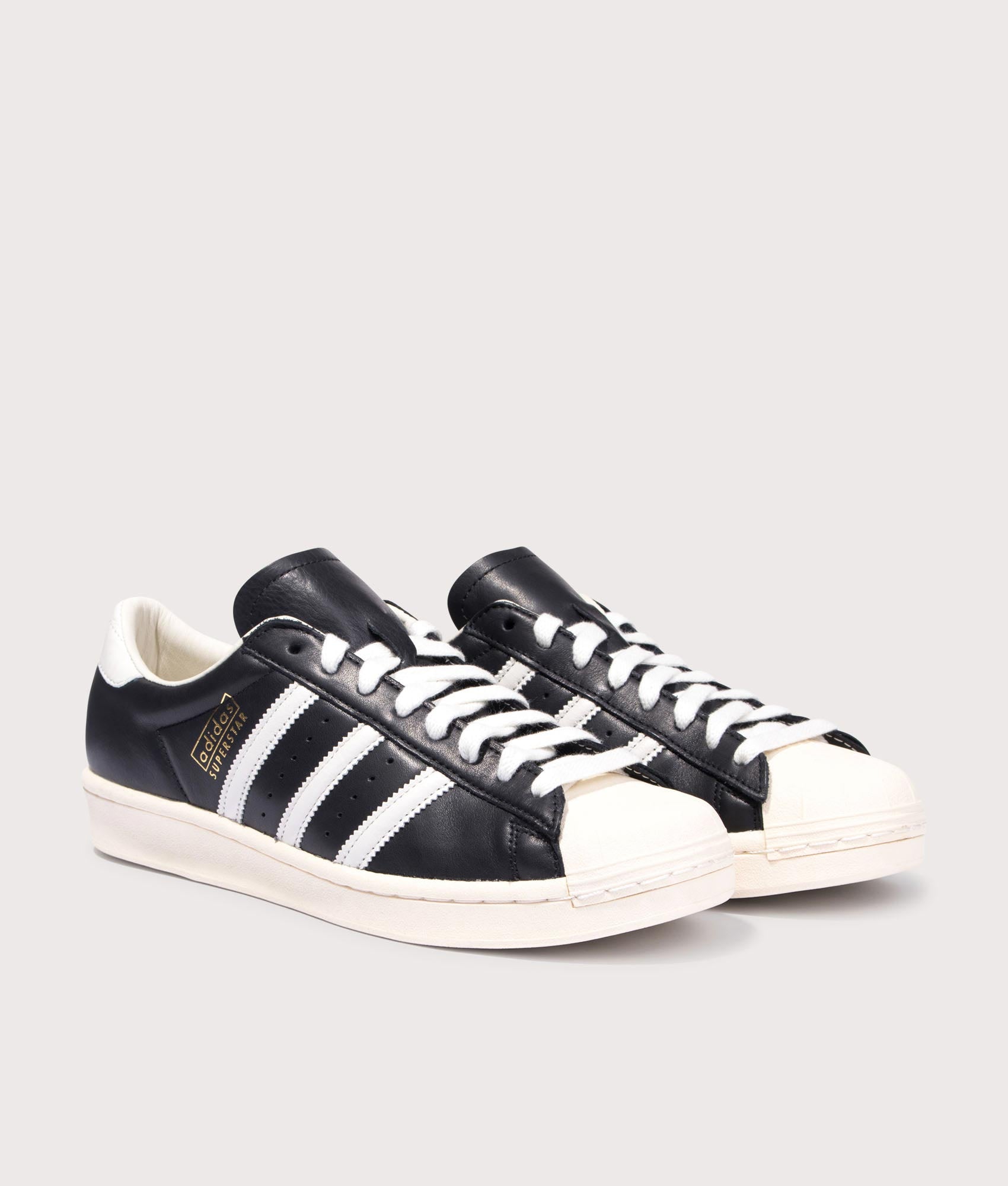 adidas Originals Superstar Vintage Trainers in Core Black, Cloud White and Cream White at EQVVS Menswear. Angled front shot.