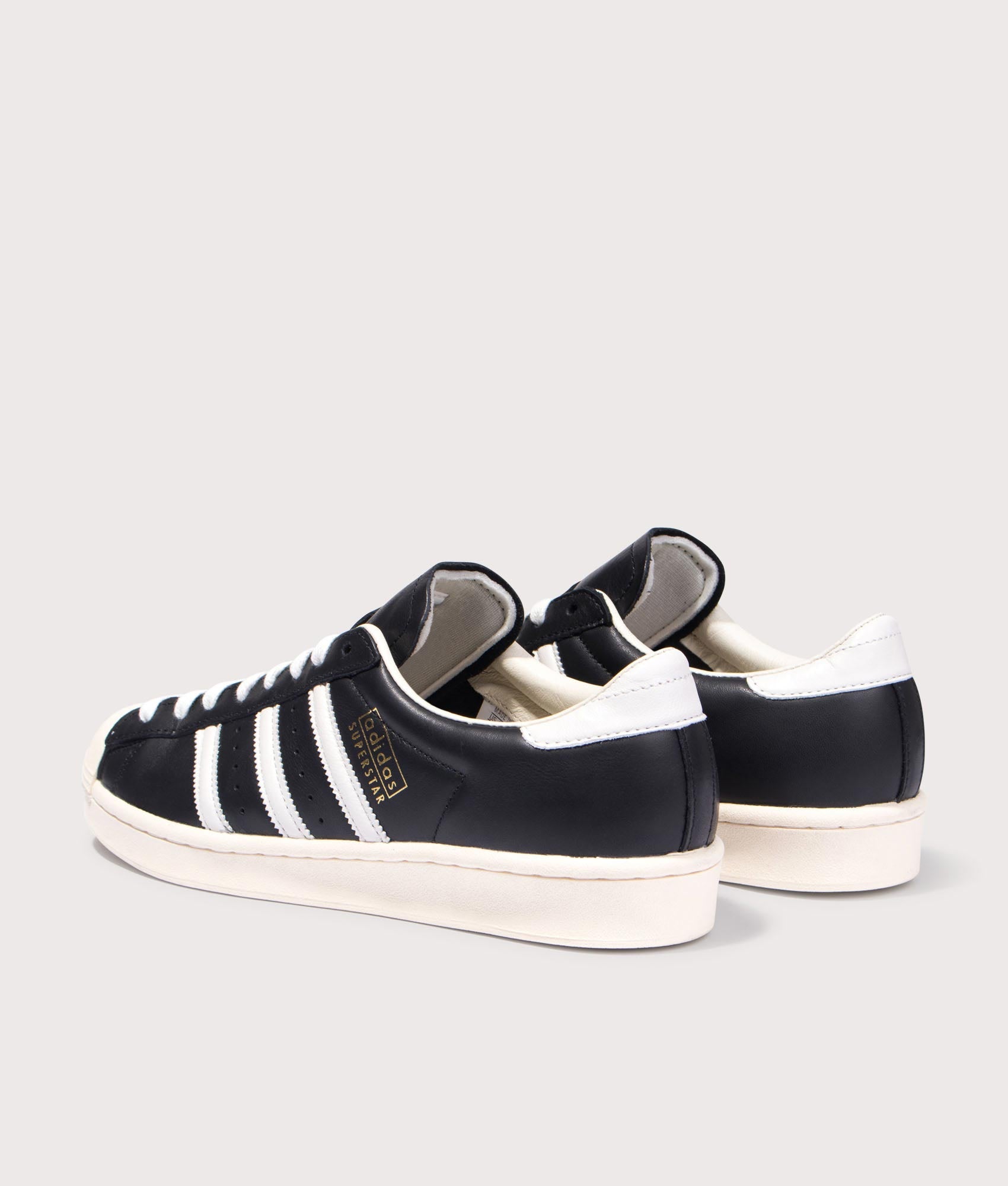 adidas Originals Superstar Vintage Trainers in Core Black, Cloud White and Cream White at EQVVS Menswear. Angled back shot.