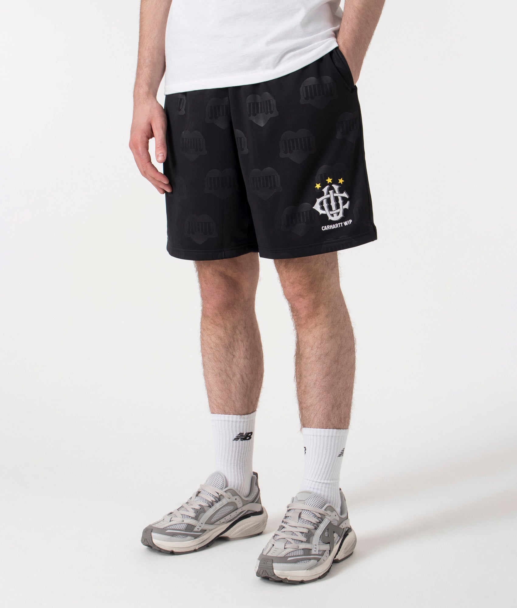 Carhartt WIP Relaxed Fit Hartt Football Shorts in Black at EQVVS Menswear. Left side shot. 