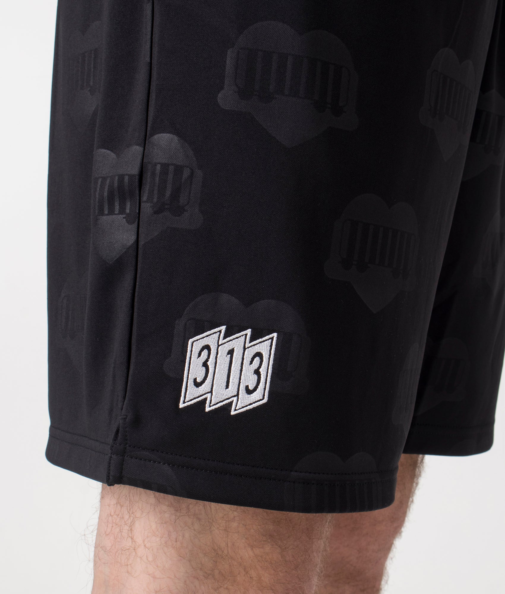 Carhartt WIP Relaxed Fit Hartt Football Shorts in Black at EQVVS Menswear. Detailed shot. 