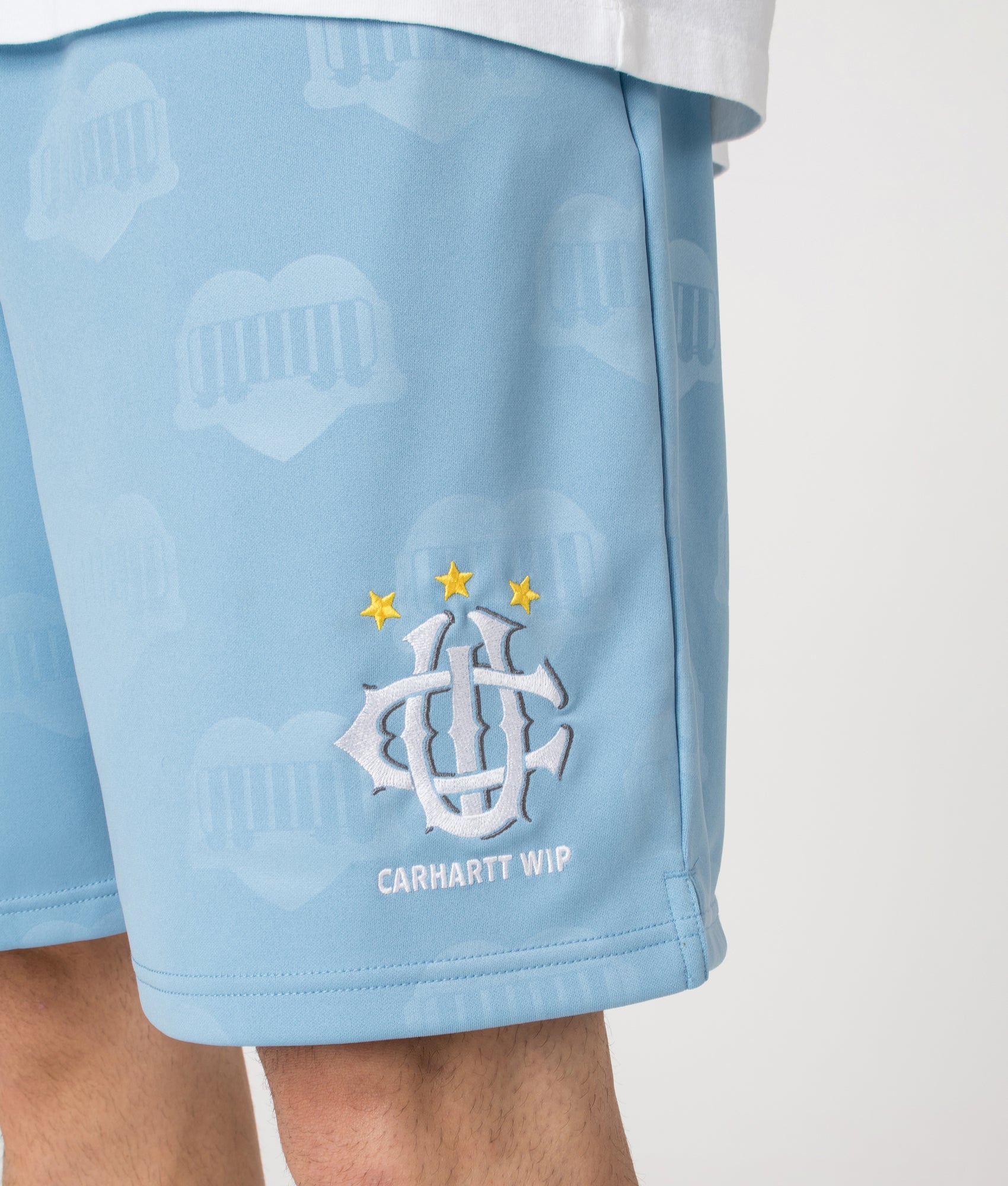 Relaxed Fit Hartt Football Shorts in Heart Train Jacquard and Bluebird. | Carhartt WIP | Shot at EQVVS | Front angle shot 