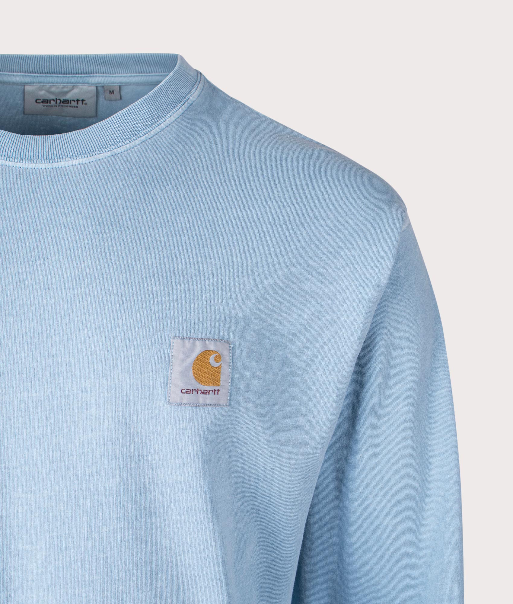 Carhartt WIP Relaxed Fit Long Sleeve Nelson T-Shirt in Clay Blue, 100% Cotton at EQVVS. Close-up shot. 