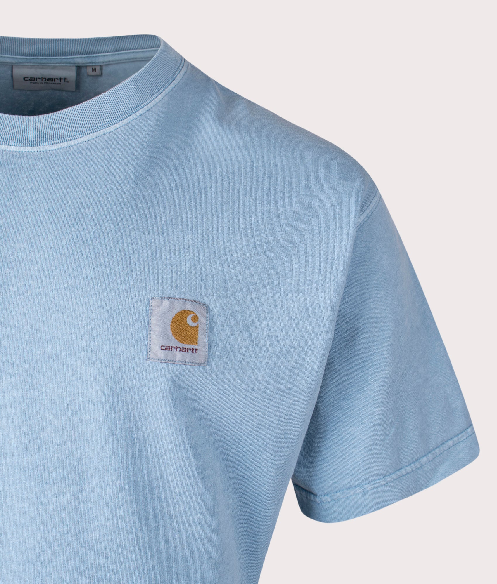 Carhartt WIP Relaxed Fit Nelson T-Shirt in Clay Blue, 100% Cotton at EQVVS. Close-up shot. 