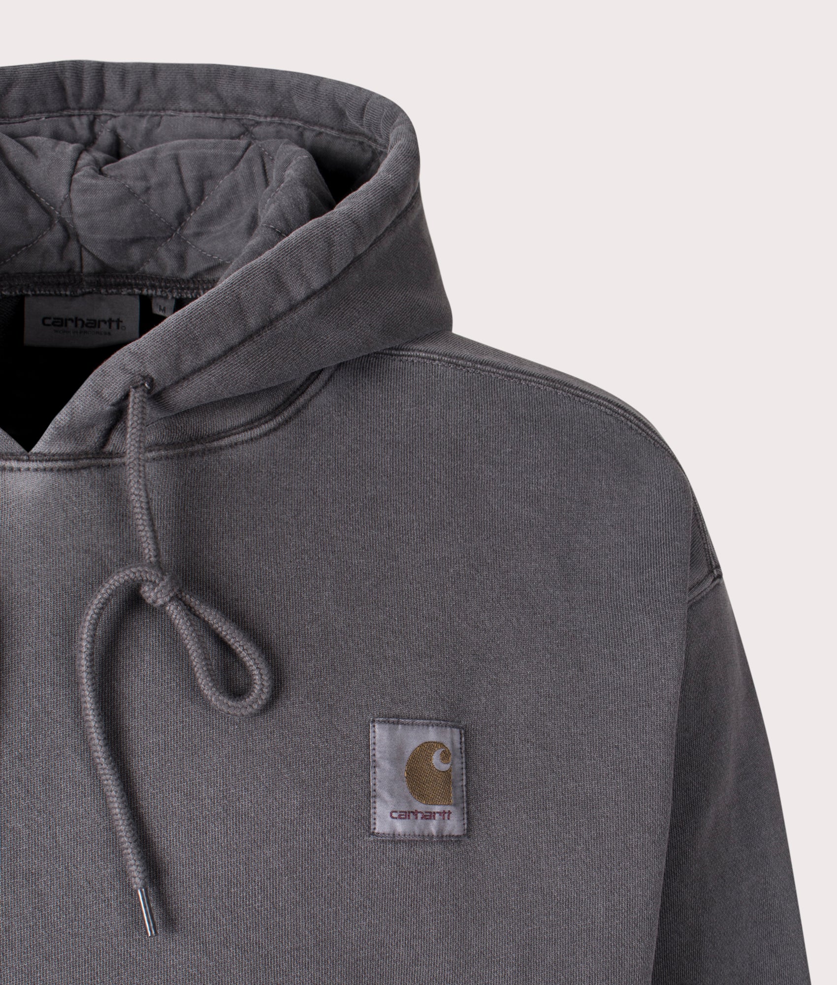 Carhartt WIP Oversized Nelson Hoodie in Graphite, 100% Cotton at EQVVS. Close-up shot.