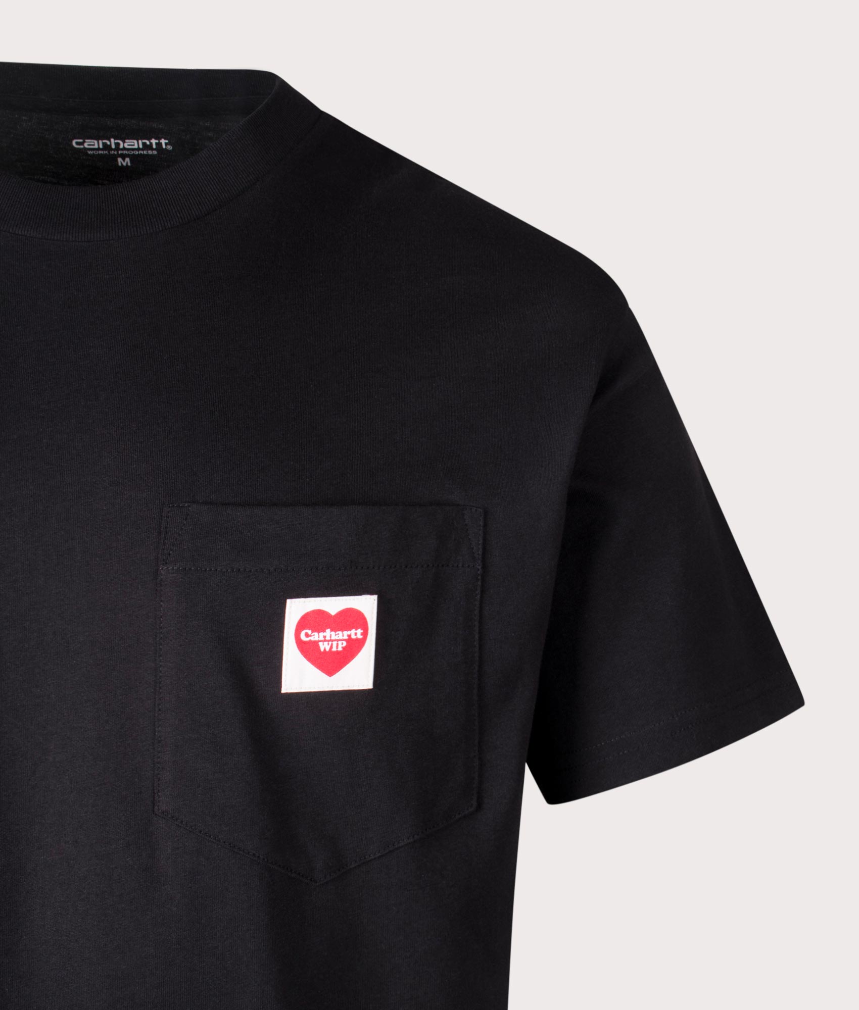 Carhartt WIP Relaxed Fit Pocket Heart T-Shirt in Black, 100% cotton at EQVVS. Close-up shot.