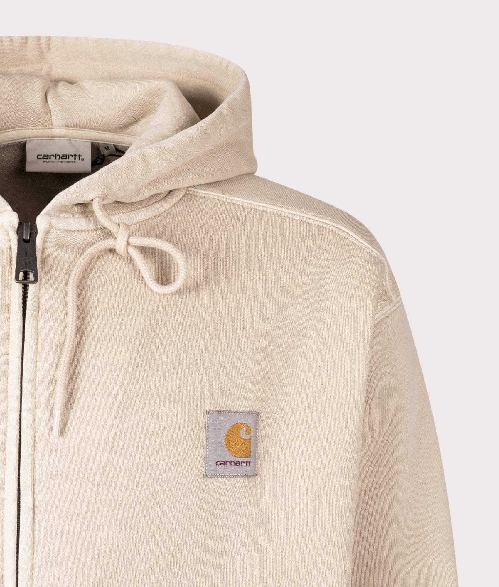Carhartt WIP Oversized Nelson Zip-Through Hoodie in Fleur De Sel, 100% cotton at EQVVS. Close-up shot. 