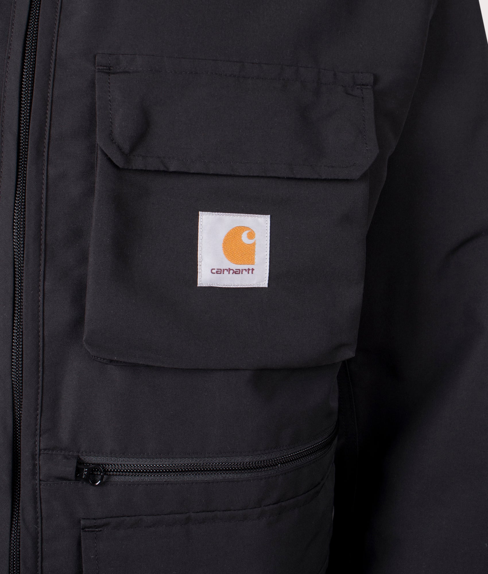 Carhartt WIP Irwin Jacket in Black at EQVVS. Detailed logo shot. 