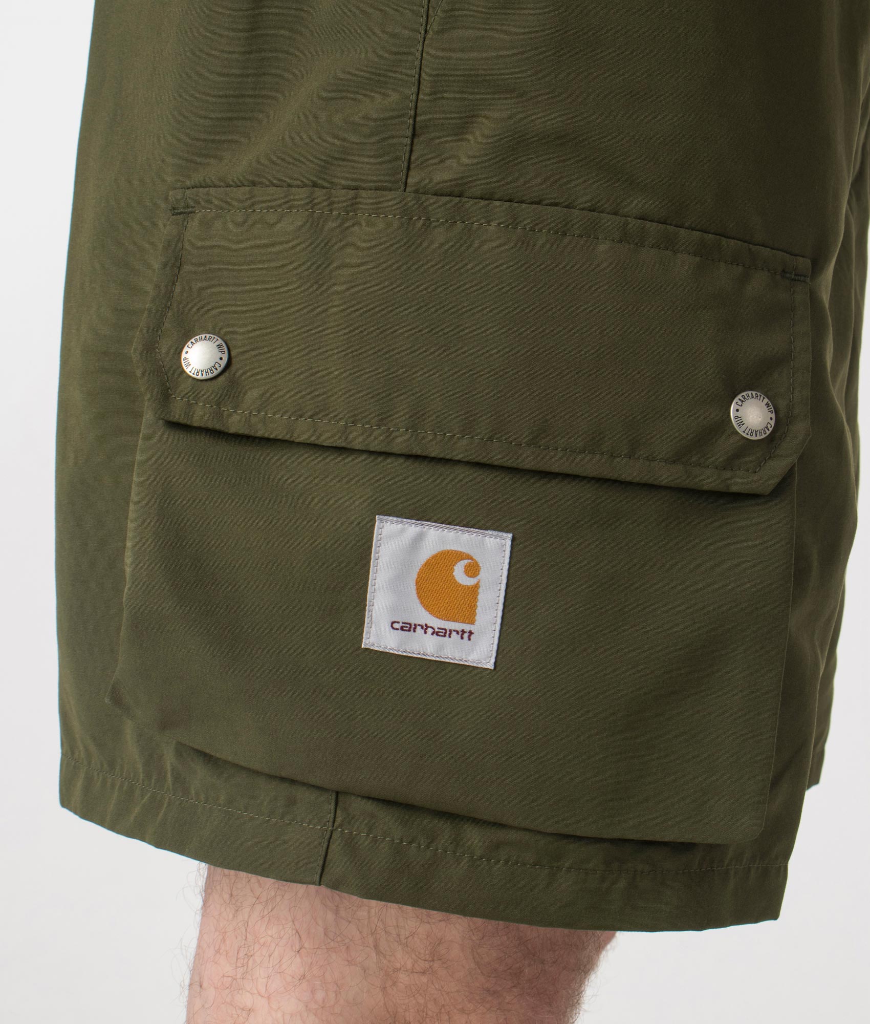 Carhartt WIP Regular Fit Irwin Shorts in Turtle at EQVVS. Close up shot. 