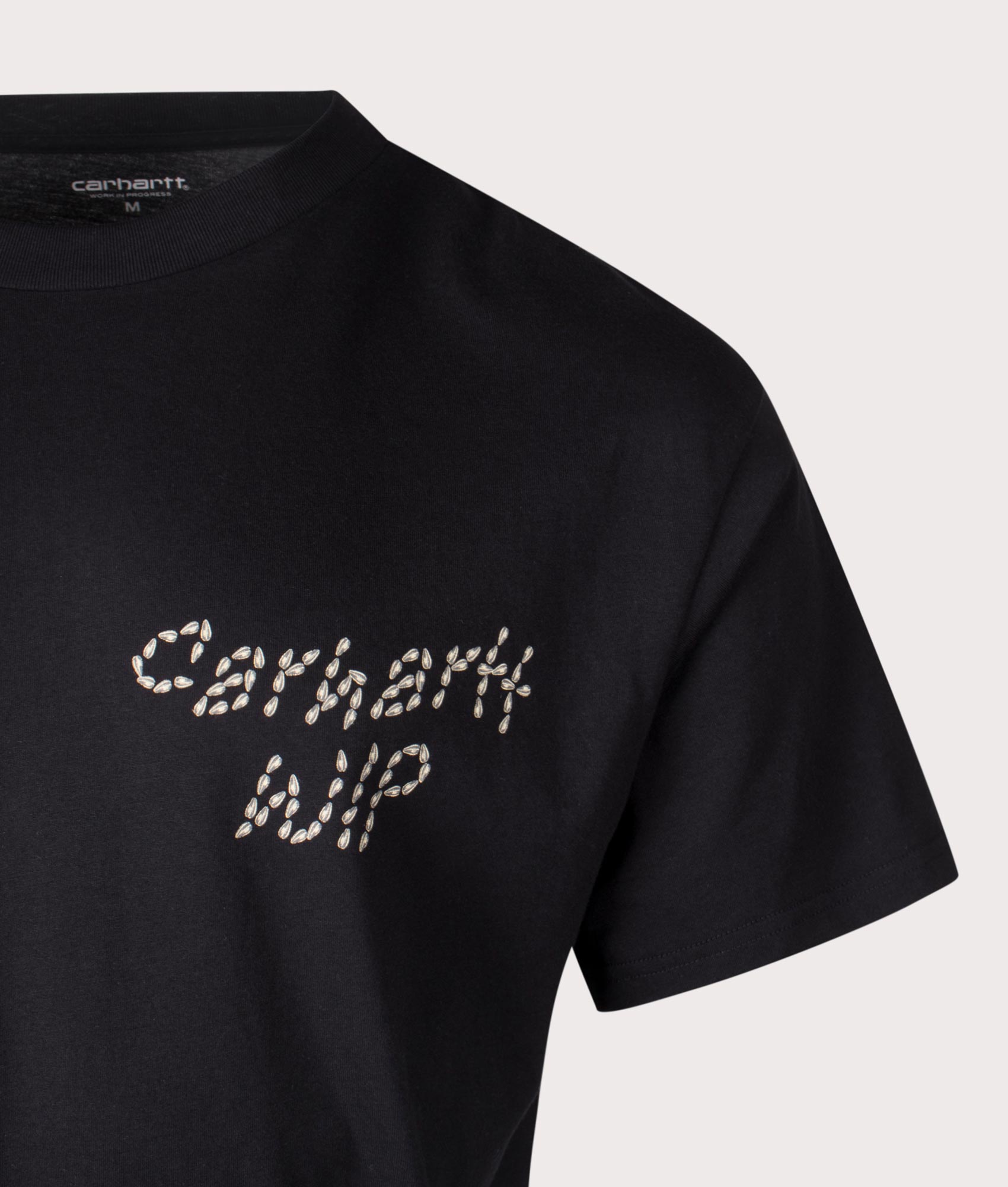 Carhartt WIP Relaxed Fit Sunflower T-Shirt in Black, 100% cotton at EQVVS. Close-up shot. 