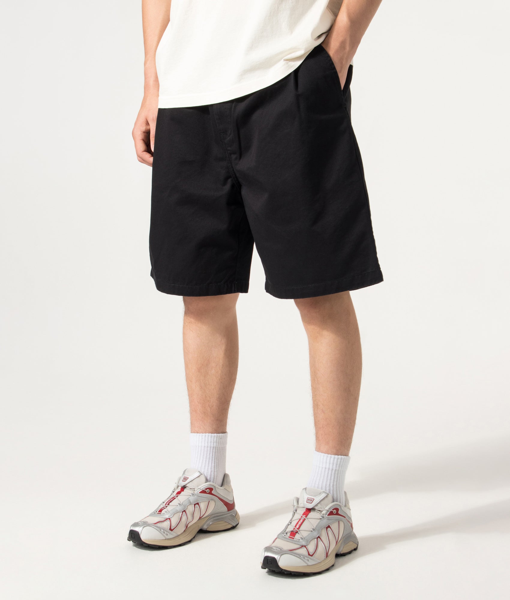 Carhartt WIP Marv Shorts in Stone Washed Black at EQVVS Menswear. Model angled front shot.