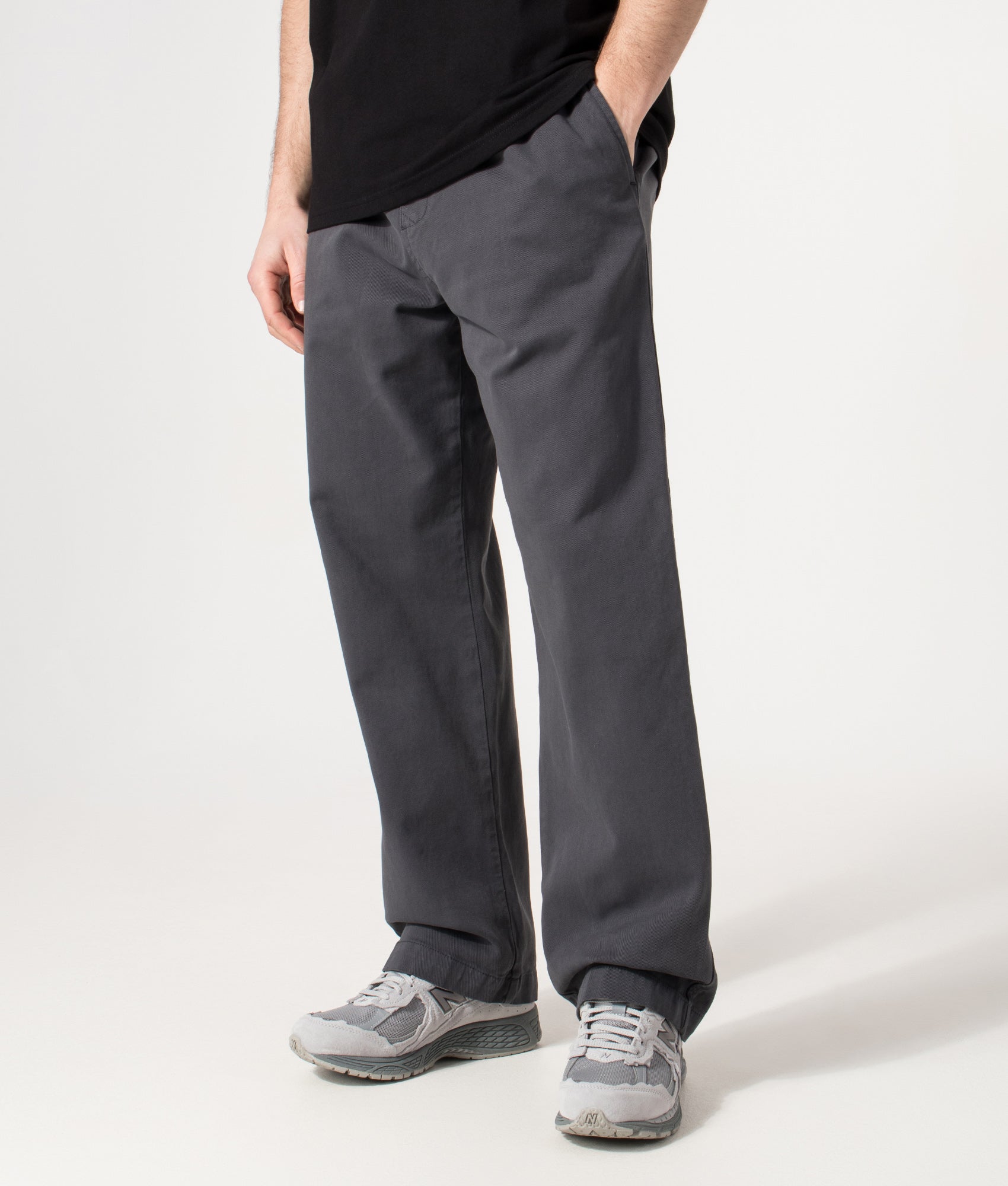 Carhartt WIP Relaxed Fit Floyde Pants in  Graphite at EQVVS Menswear. Angled model front shot.