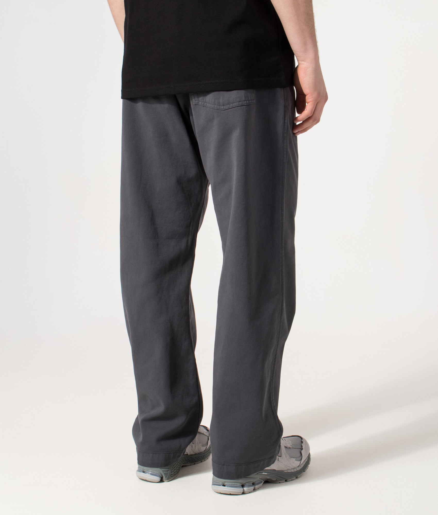 Carhartt WIP Relaxed Fit Floyde Pants in  Graphite at EQVVS Menswear. Model back shot.