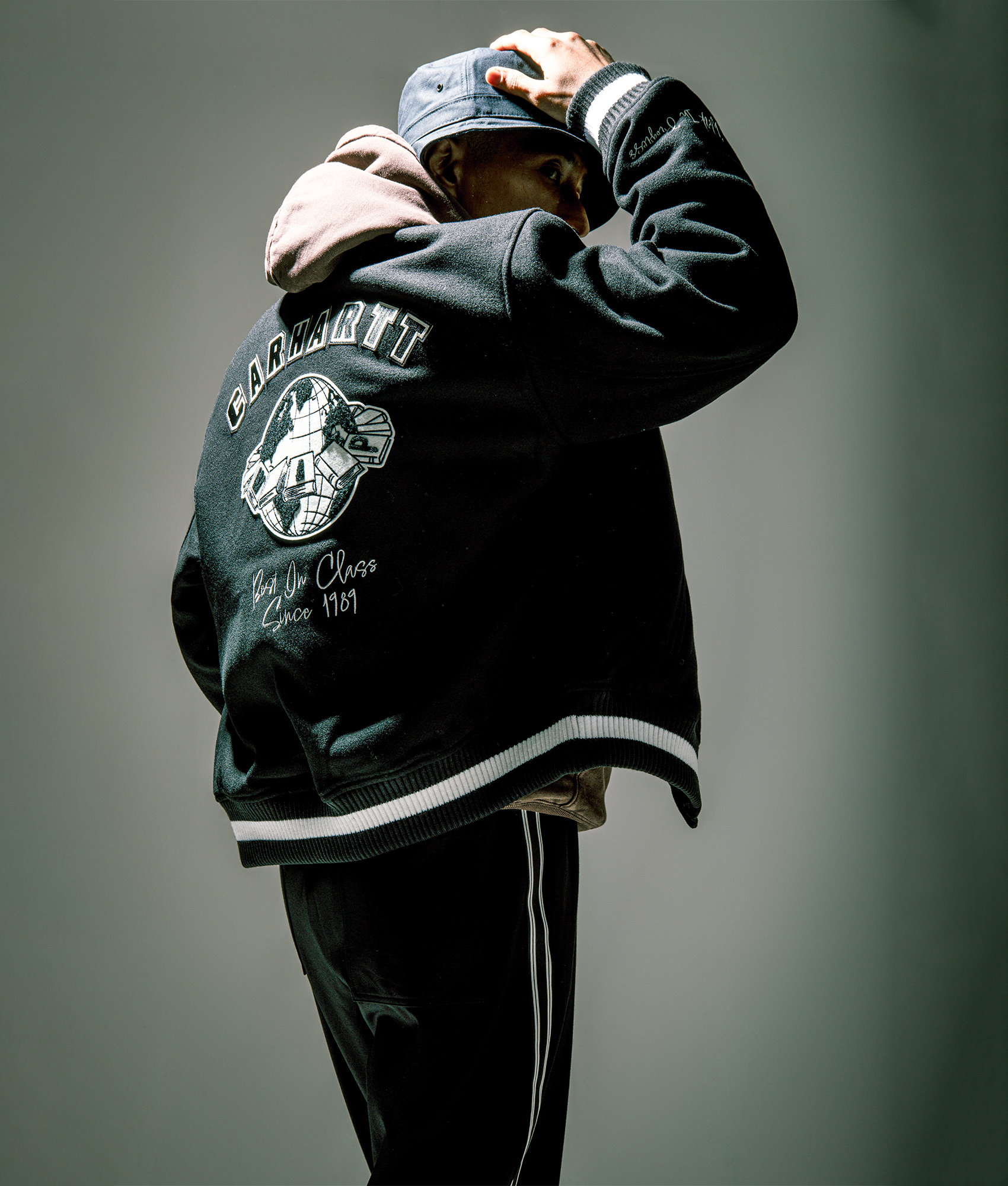 Carhartt WIP World Class Varsity in Black at EQVVS Menswear. Campaign shot.