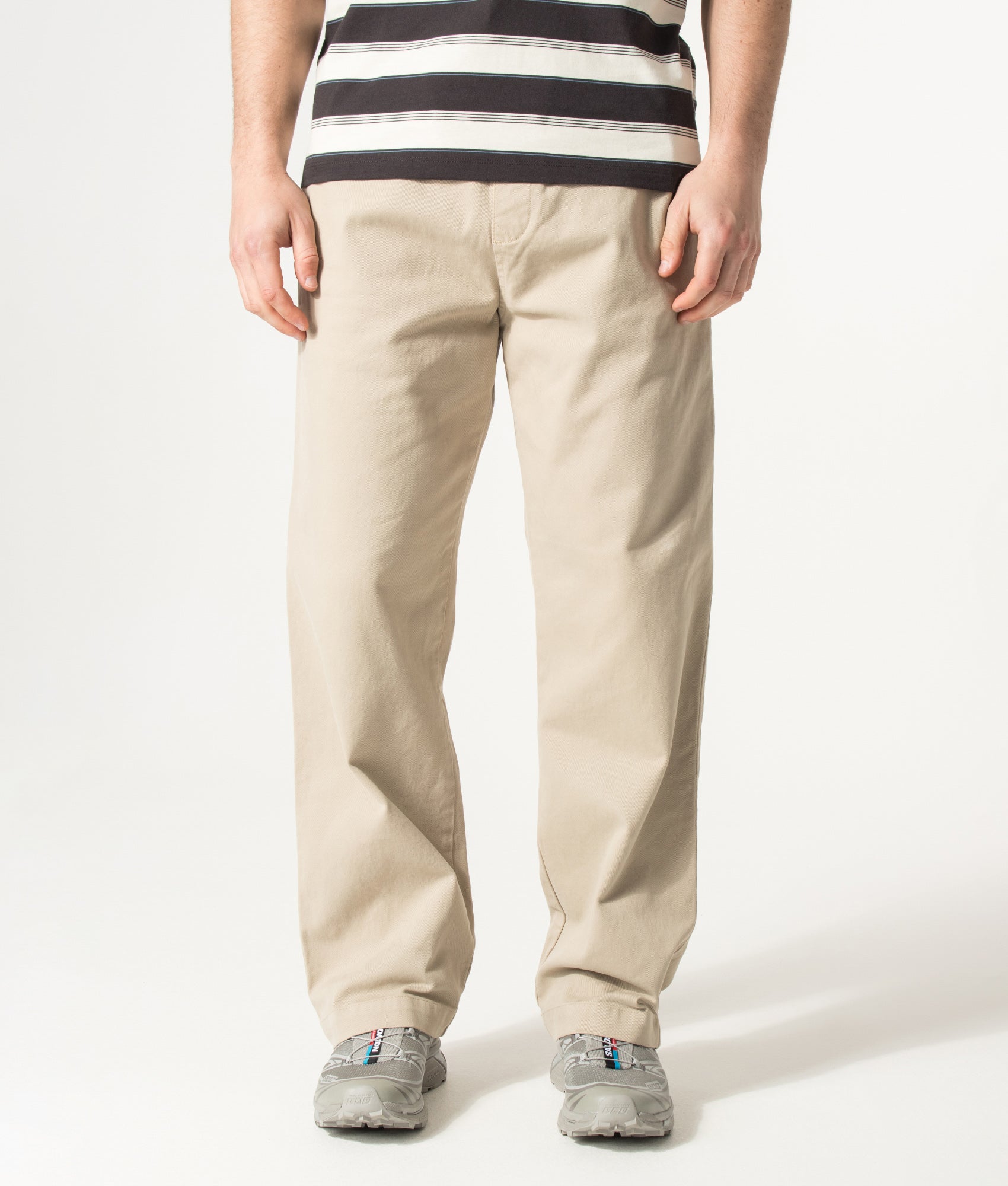 Carhartt WIP Relaxed Fit Floyde Pants in Wall at EQVVS Menswear. Model front shot.
