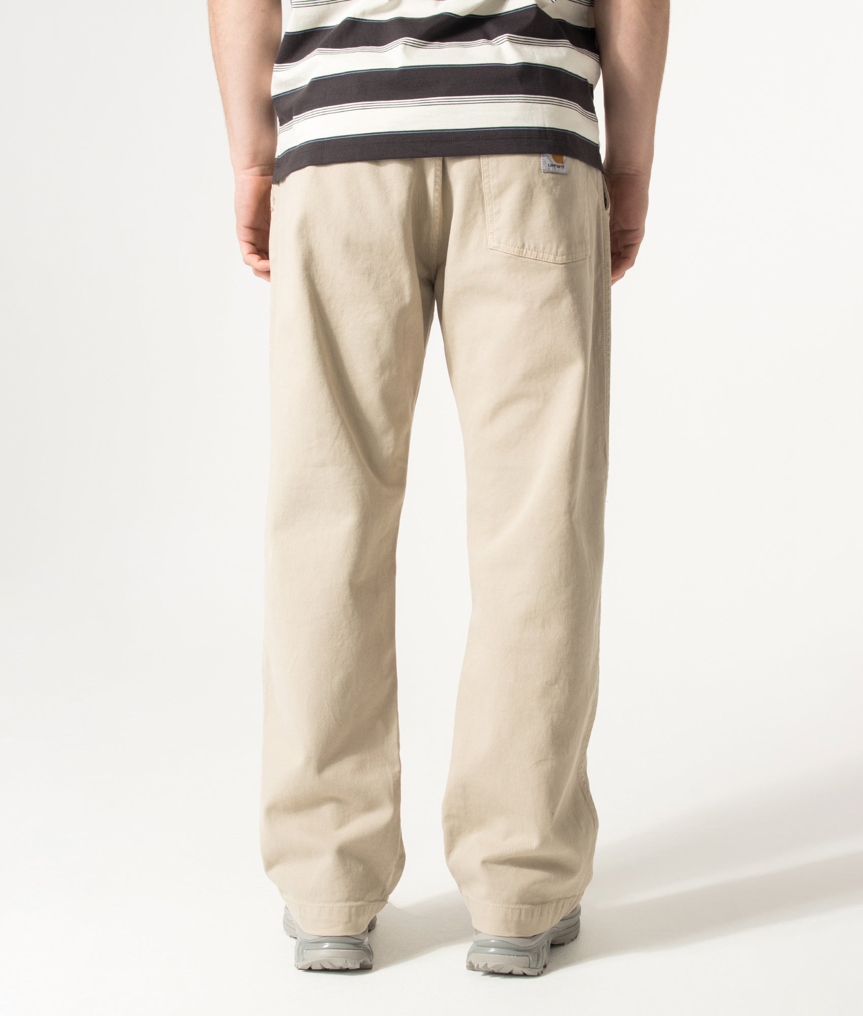 Carhartt WIP Relaxed Fit Floyde Pants in Wall at EQVVS Menswear. Model back shot.