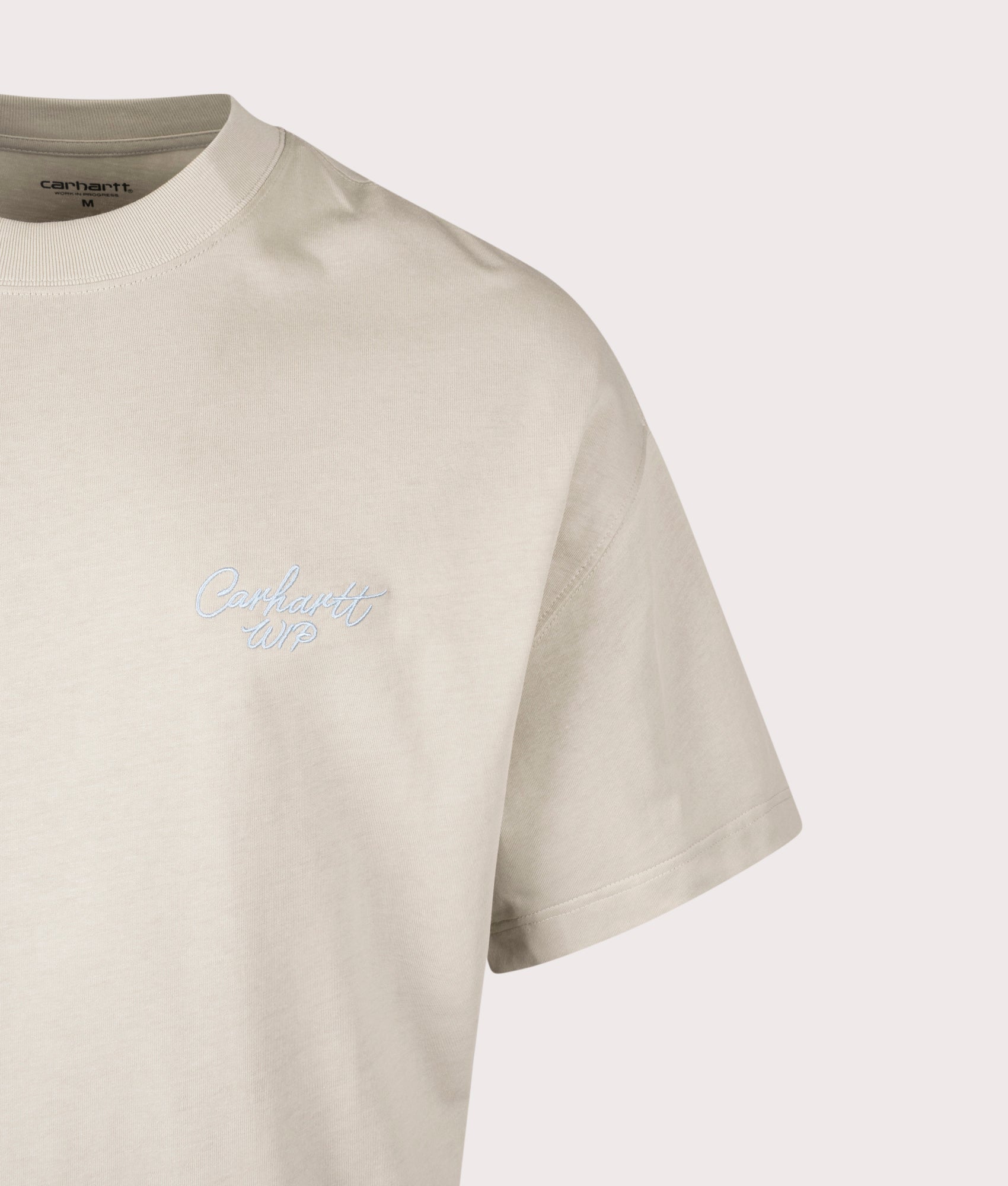 Carhartt WIP Relaxed Fit Signature Script T-Shirt in Fleur De Sel at EQVVS Menswear. Detail shot.