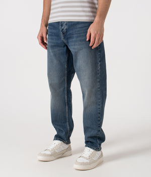 Relaxed Fit Newel Jeans in 014L Blue. 100% Cotton | Carhartt WIP | Shot at EQVVS | Front shot angled