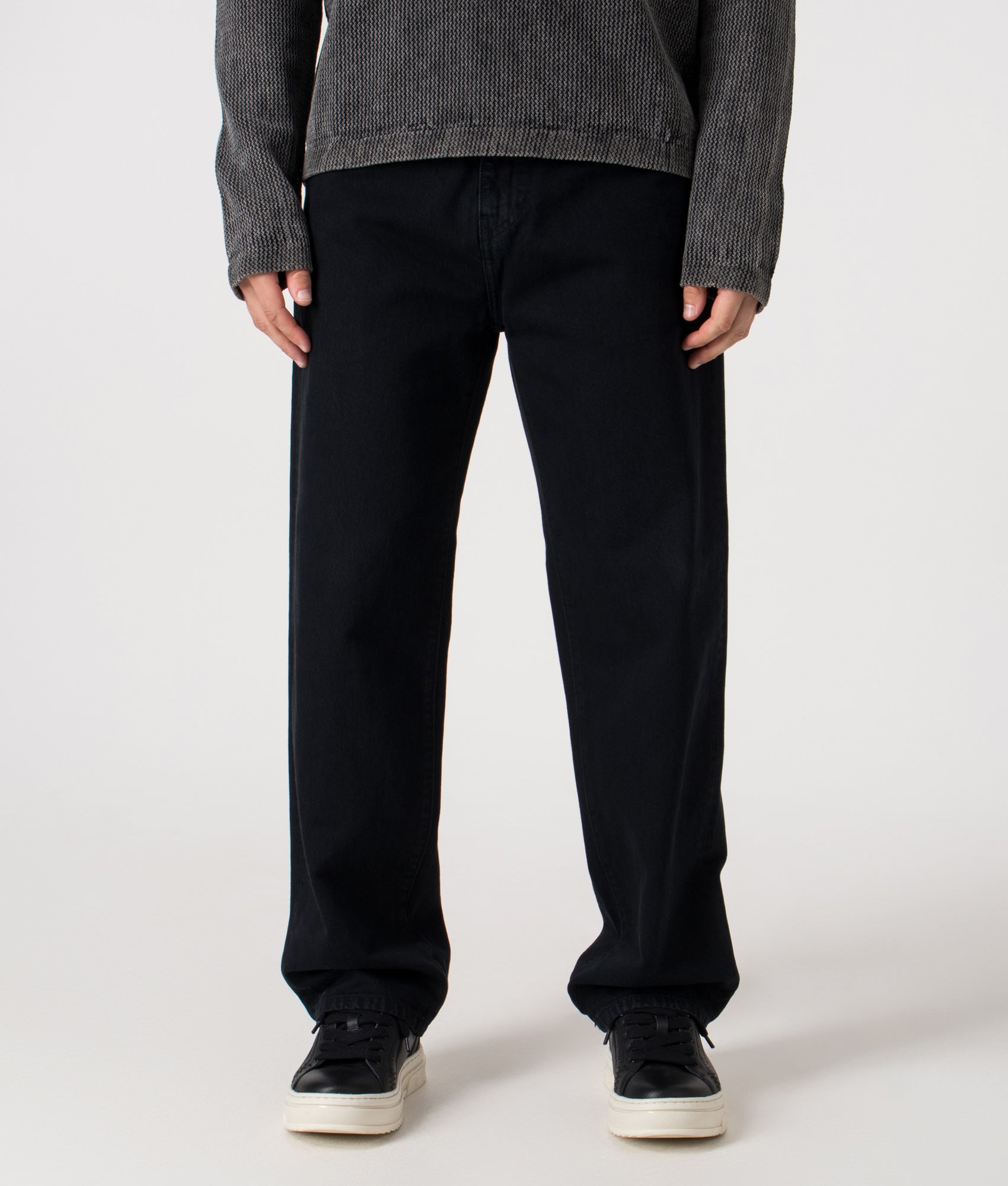 Carhartt WIP Relaxed Fit Aaron Pants in 01LF Blue at EQVVS Menswear. Model front shot.