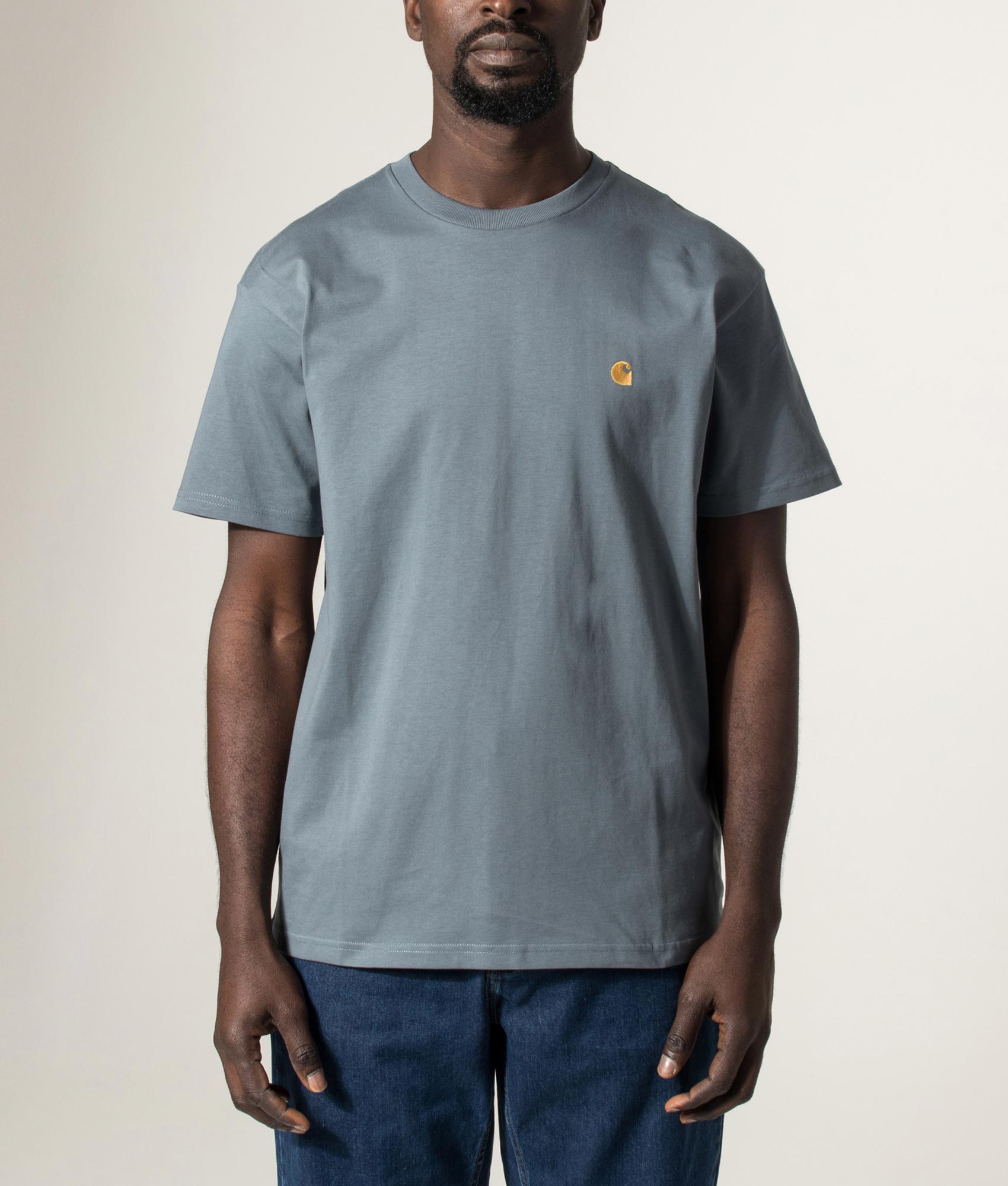 Carhartt WIP Loose Fit Chase T-Shirt in Cozy Blue and Gold at EQVVS Menswear. Model front shot.
