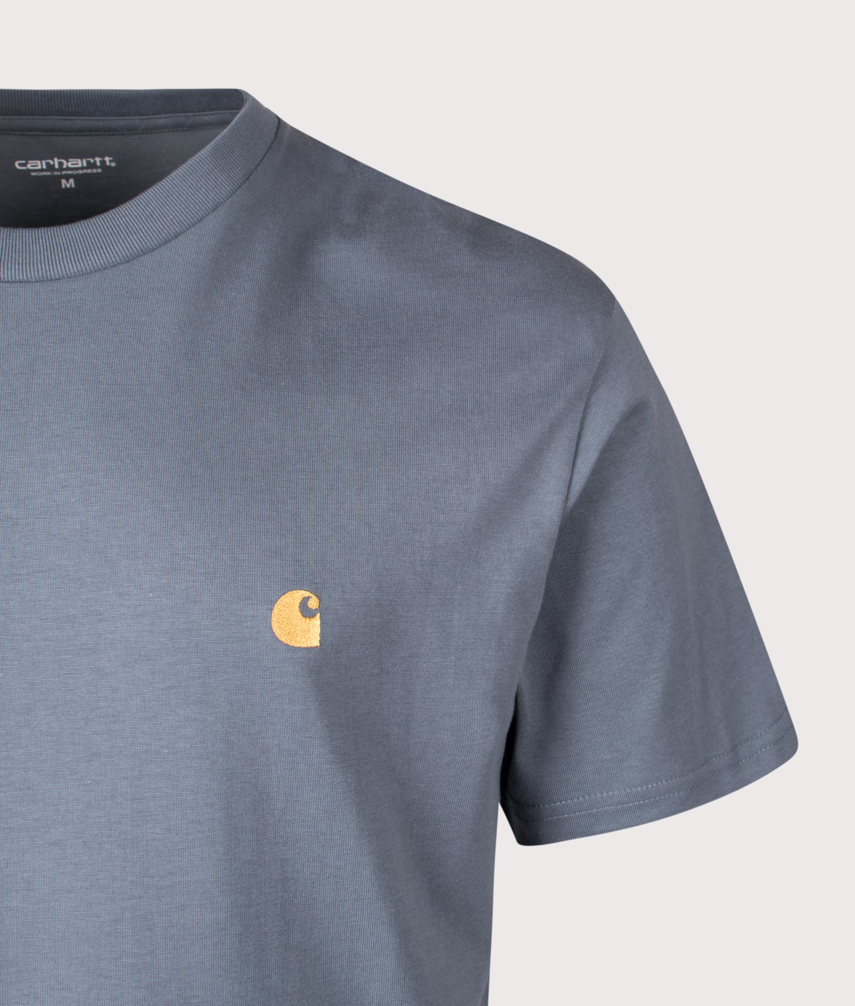 Carhartt WIP Relaxed Fit Chase T-Shirt in Cozy Blue and Gold at EQVVS Menswear. Detail shot.