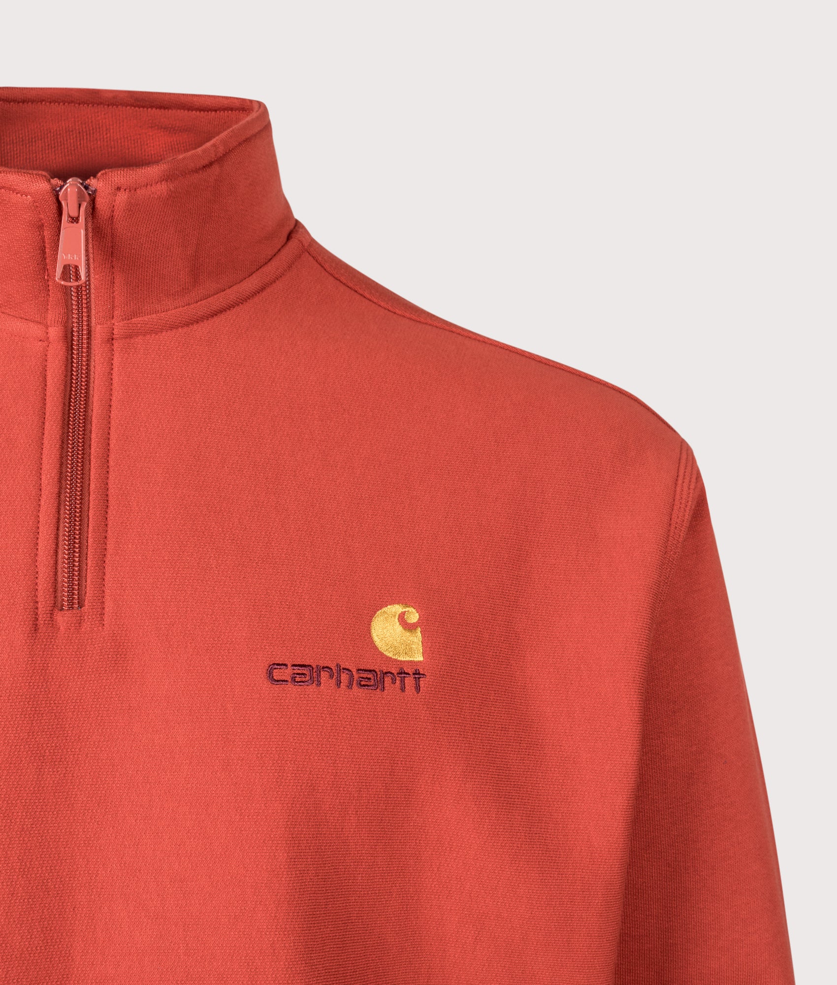 Carhartt WIP Relaxed Fit Quarter Zip American Script Sweatshirt in Oxide Red at EQVVS Menswear. Detail shot.