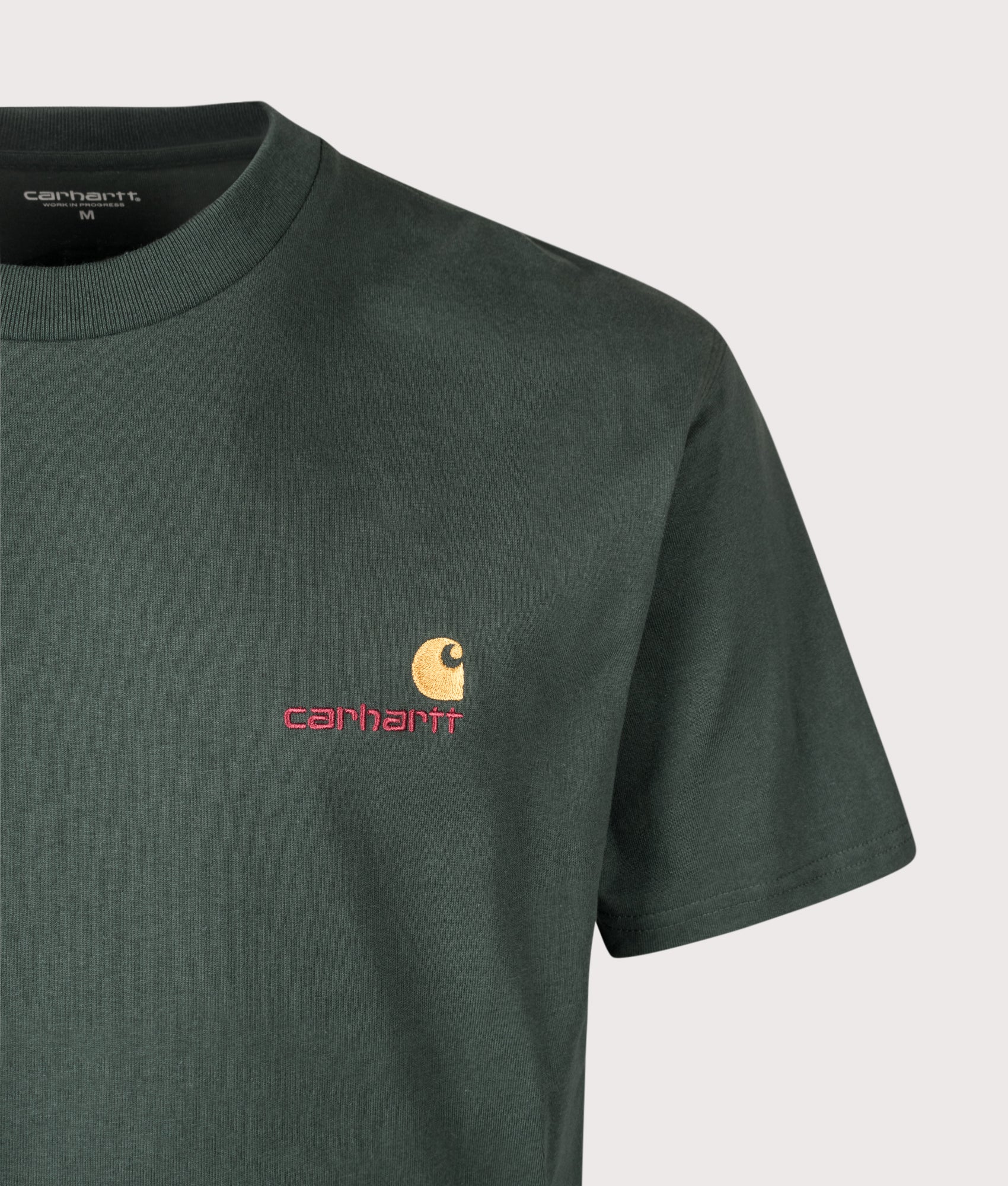 Carhartt WIP Loose Fit American Script T-Shirt in Kale Green at EQVVS Menswear. Detail shot.