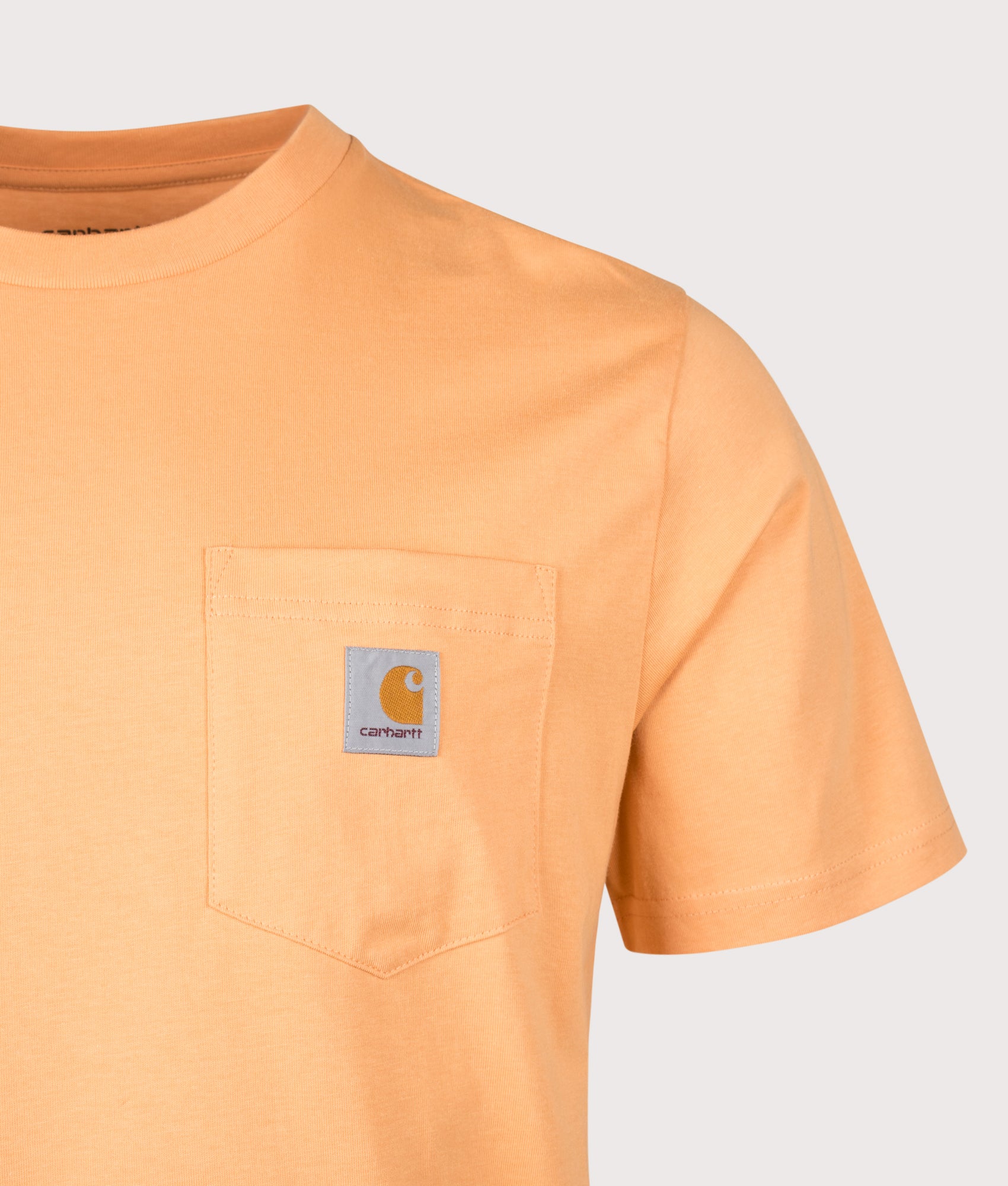 Carhartt WIP Pocket T-Shirt in Gentle Orange at EQVVS Menswear. Back shot.