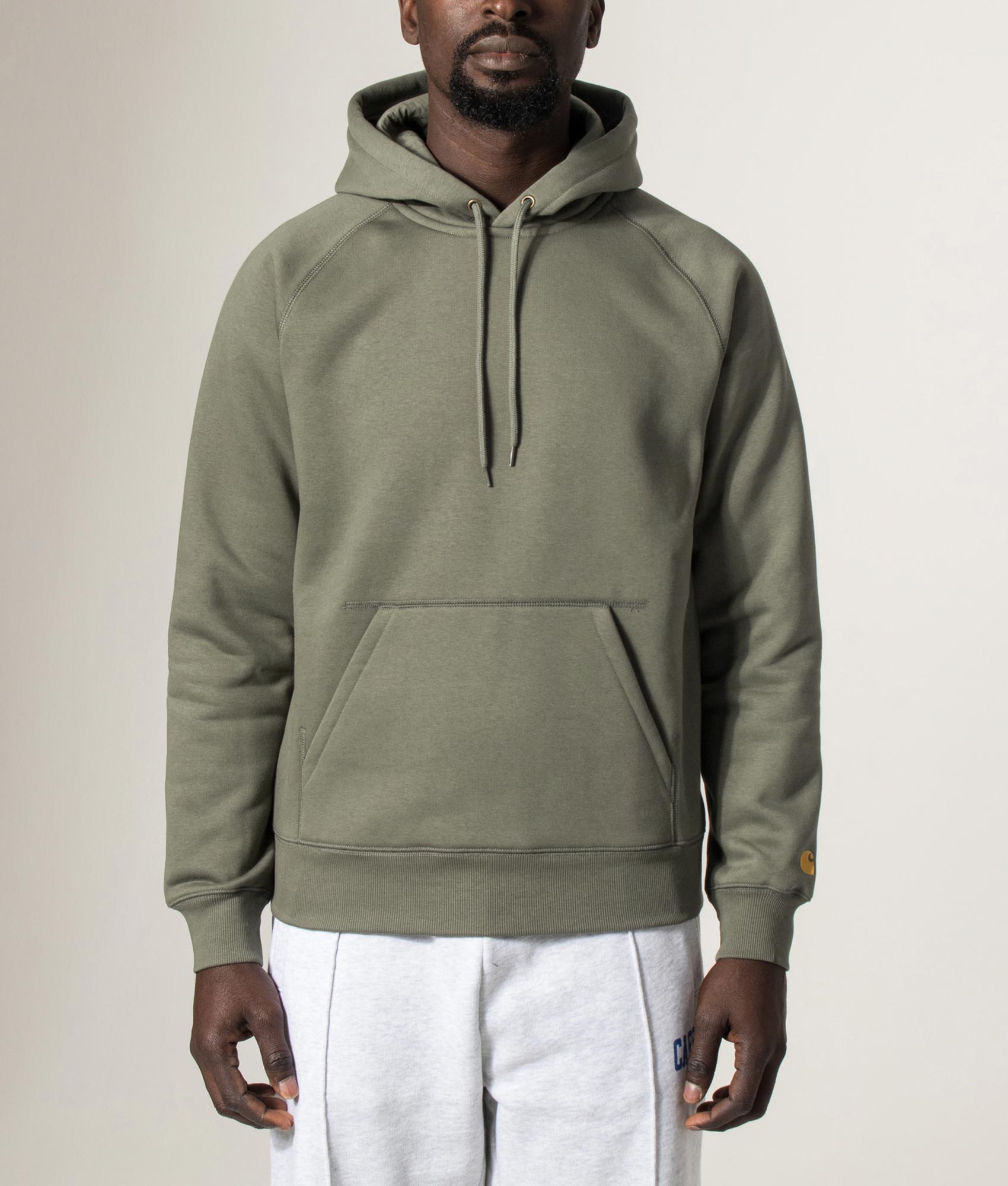 Carhartt WIP Chase Hoodie in Leaf and Gold at EQVVS Menswear. Model front shot.